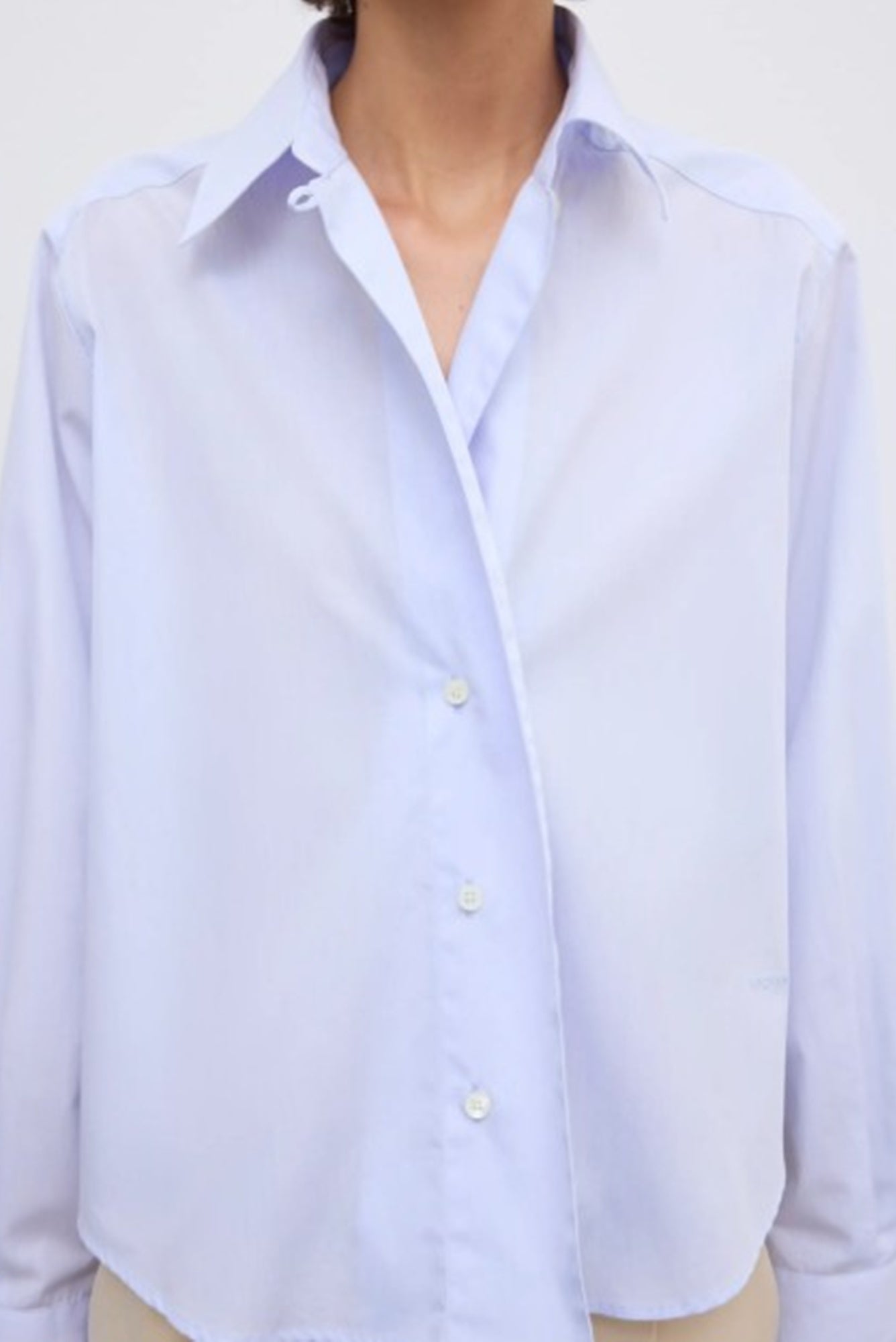 close up image of a model wearing the House of Dagmar cropped shirt in light blue