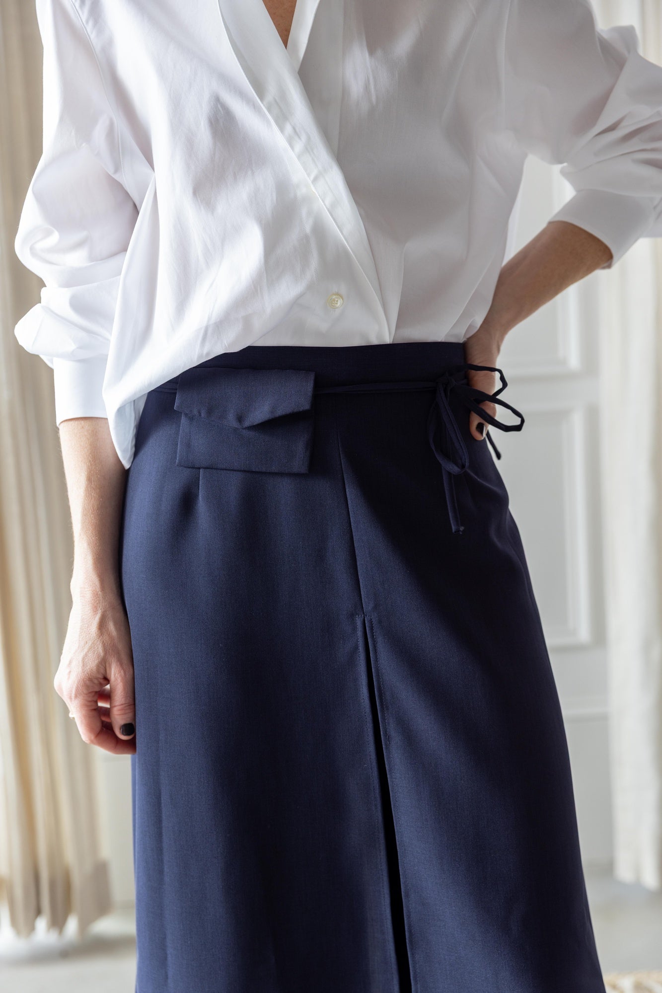 close up image of a woman wearing the house of dagmar cropped shirt and rachel comey gerri pants