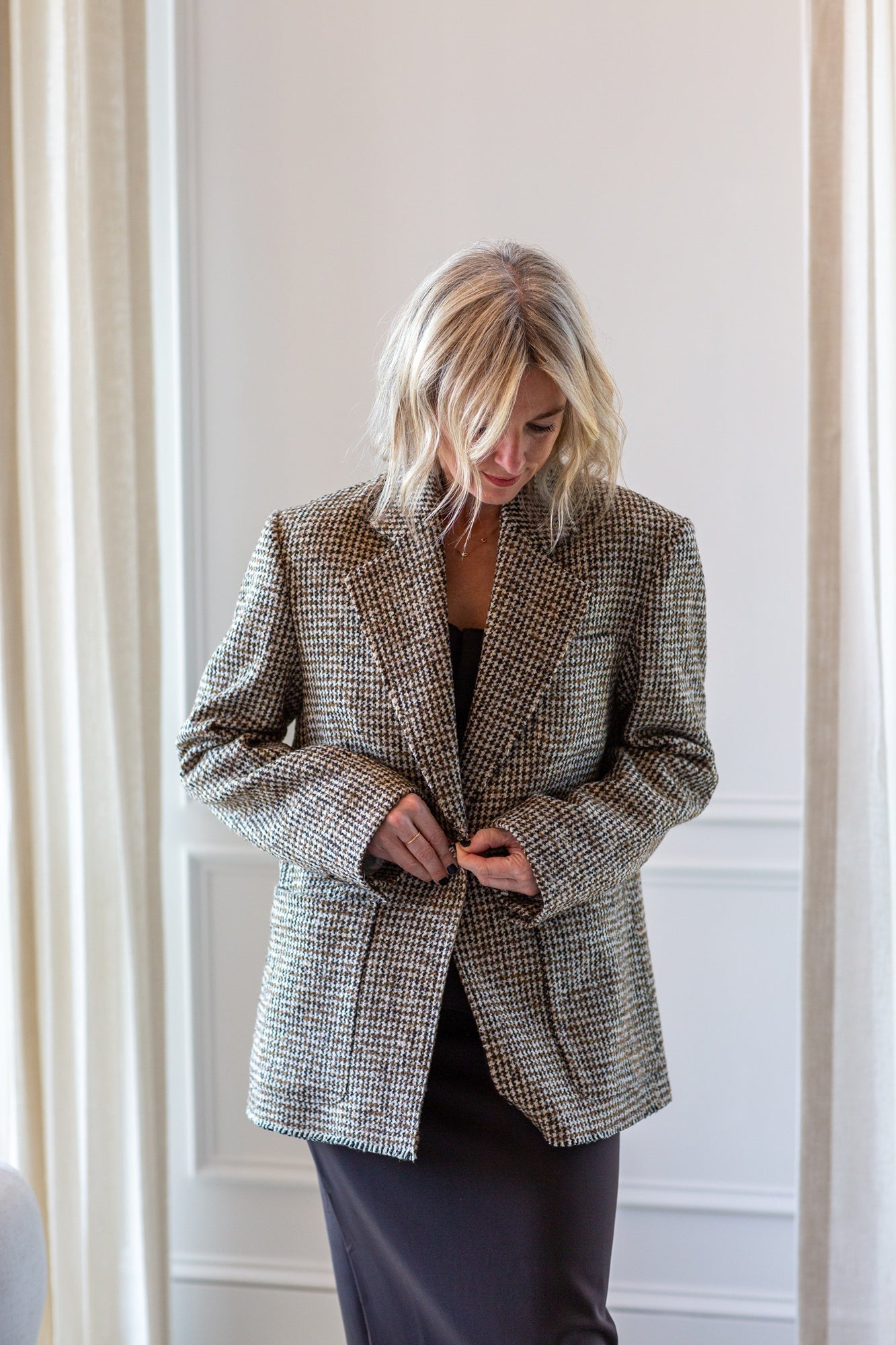 model wearing the house of dagmar houndstooth blazer and sculpted tube dress