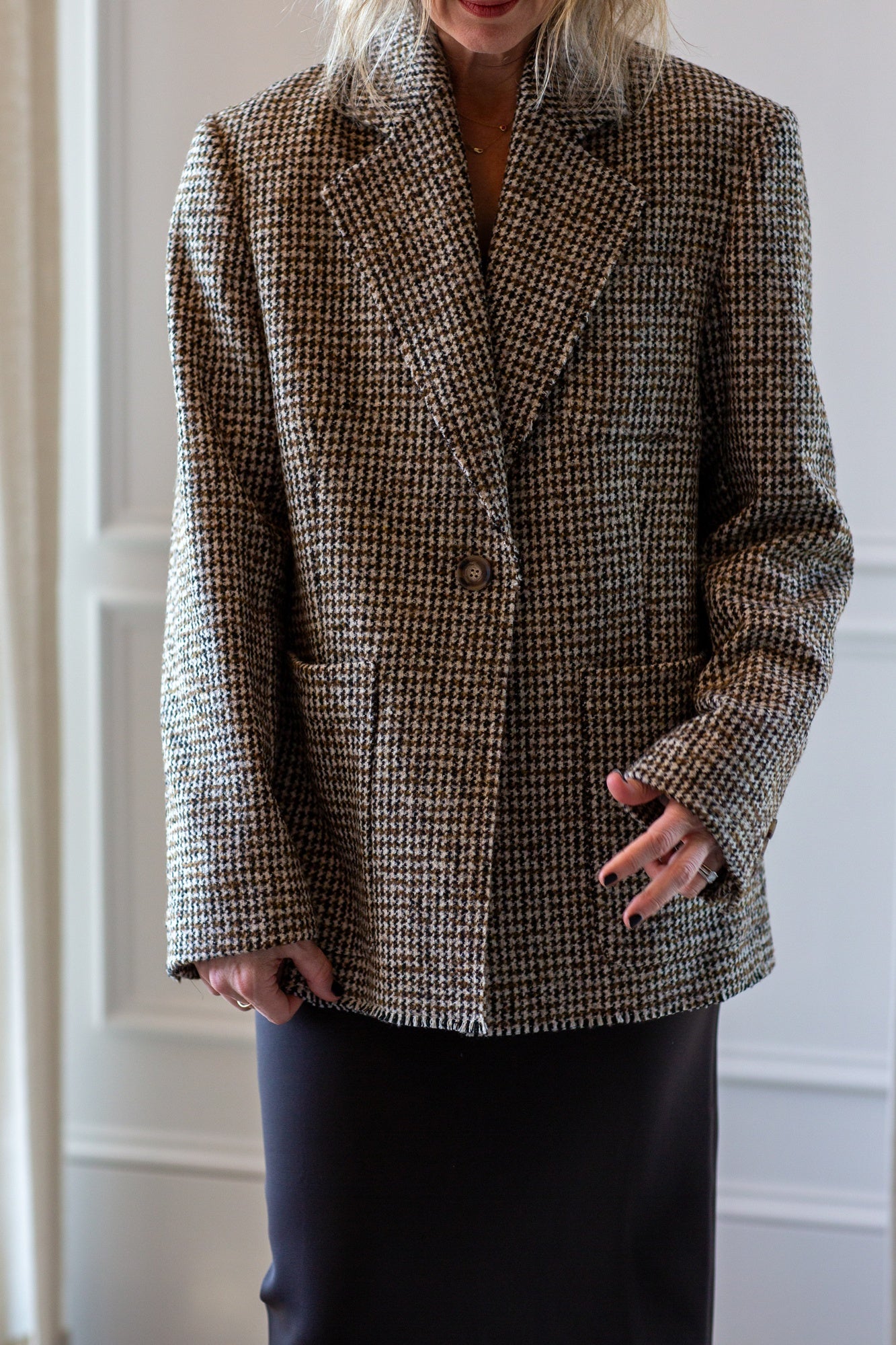 model wearing the house of dagmar houndstooth blazer and sculpted tube dress