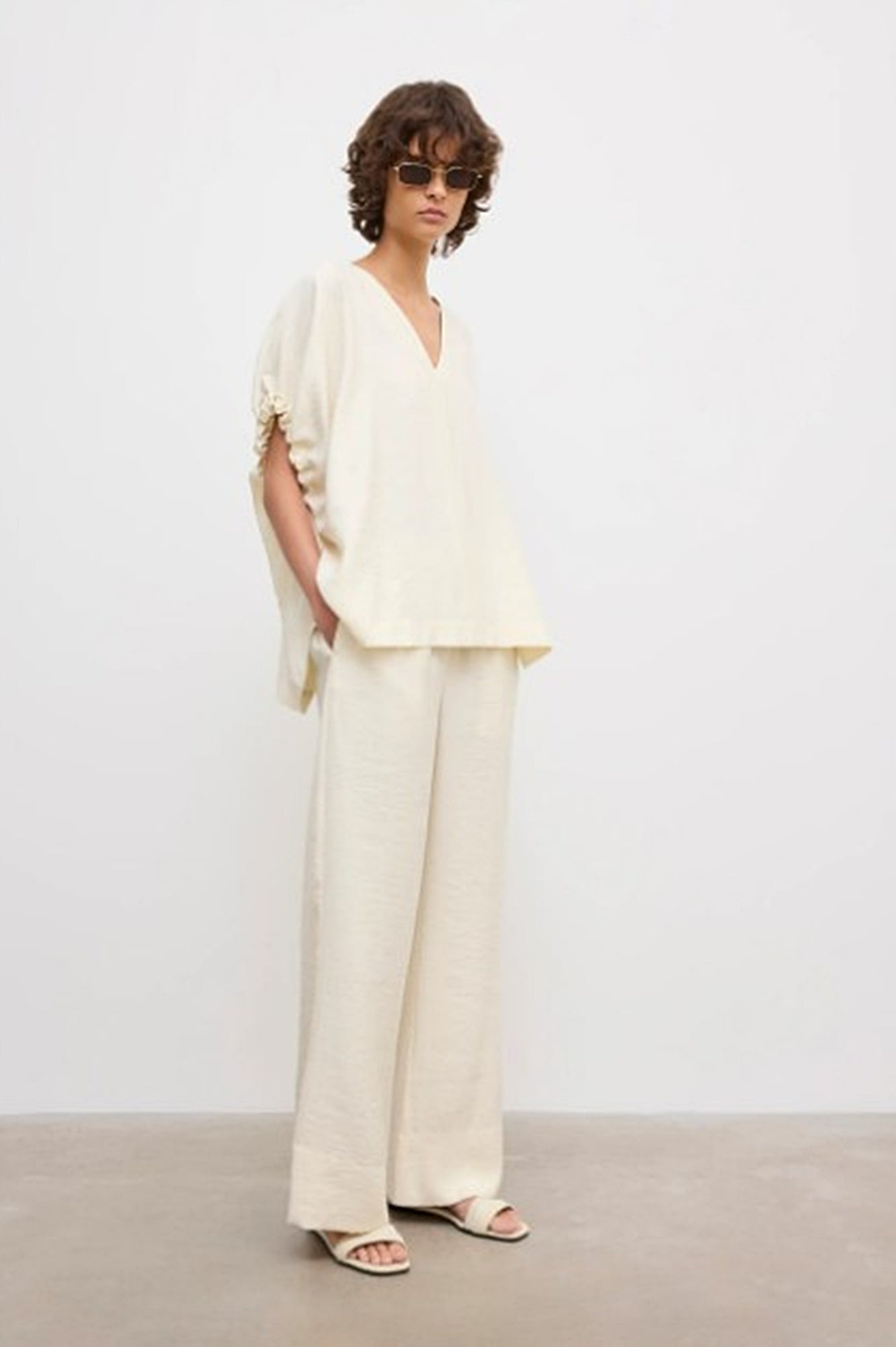 image of a woman wearing the House of Dagmar Rouched Short Sleeve Top and Drawstring Trousers in Ivory