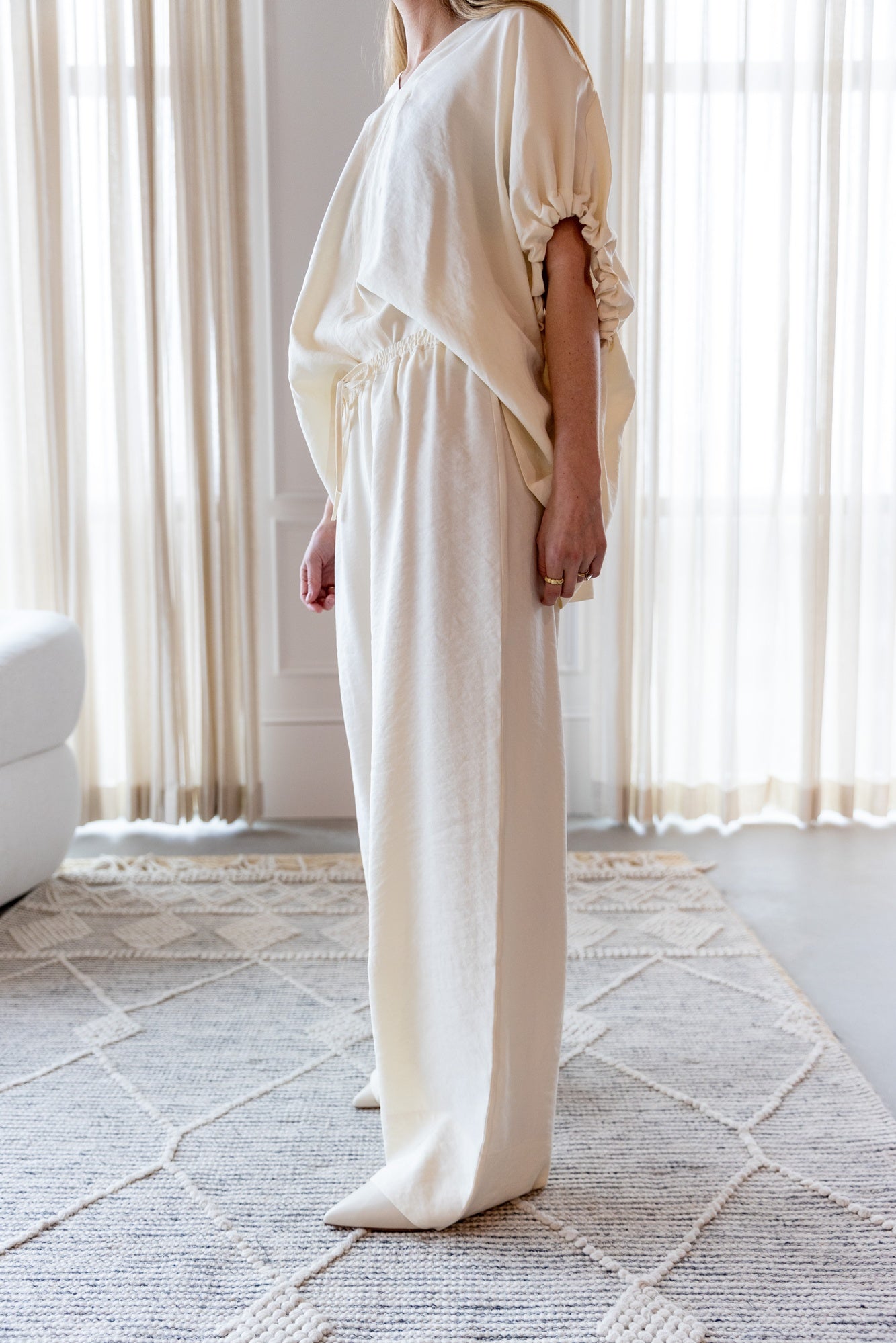 image of a woman wearing the House of Dagmar Ruched V Neck Top and Drawstring Pants