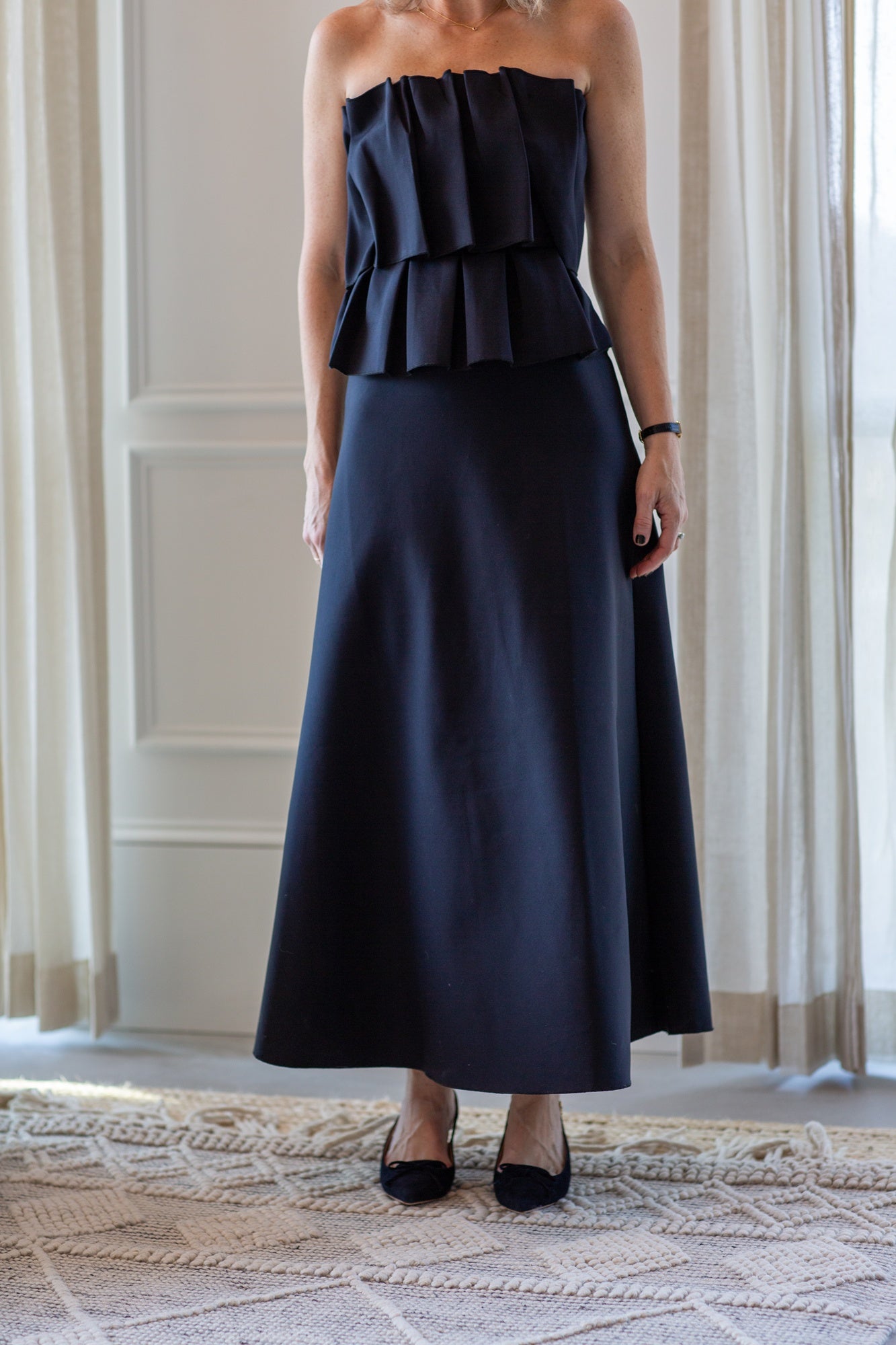 woman wearing the house of dagmar sculpted tube dress in black
