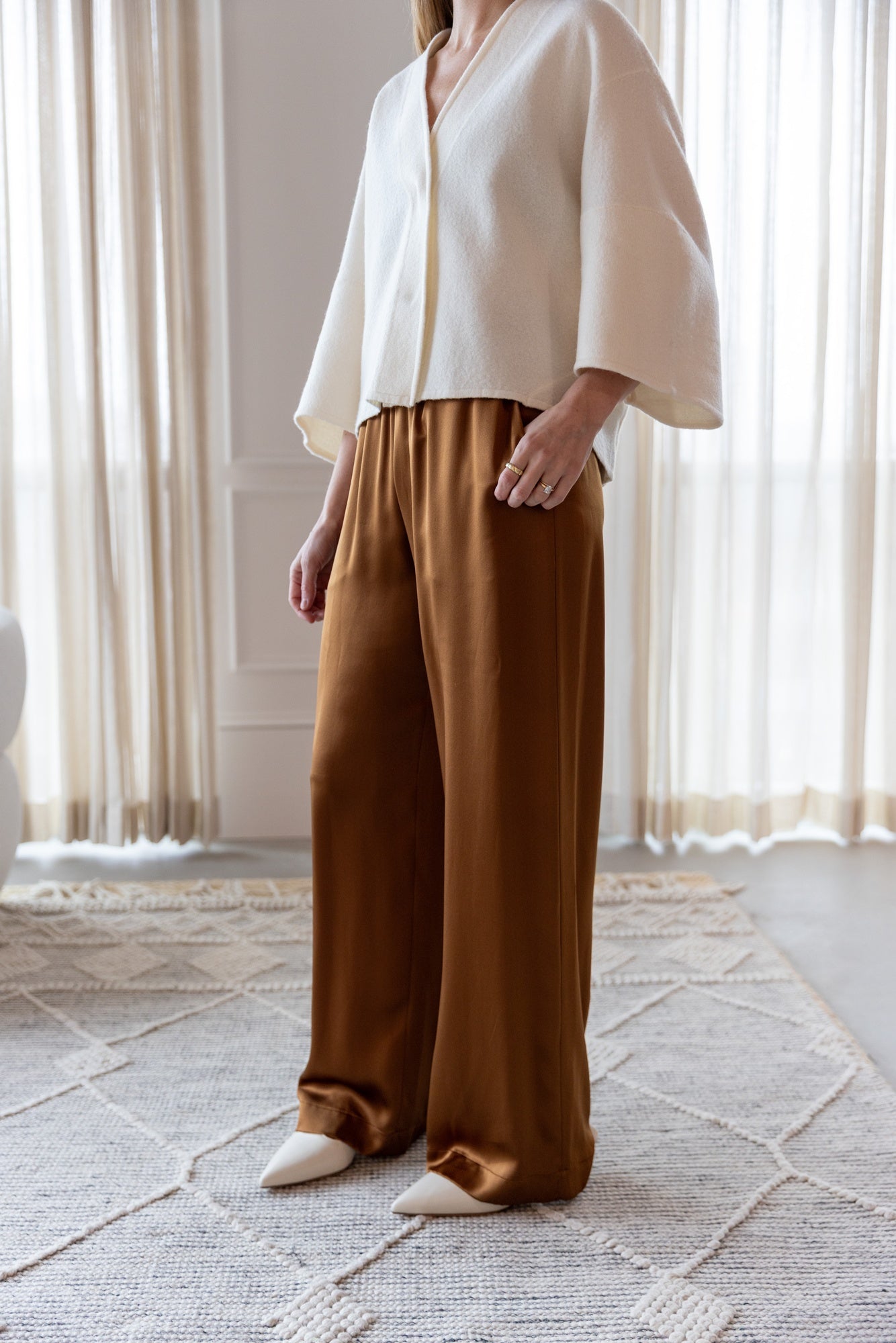 image of a woman wearing the House of Dagmar Wool Cardigan and Sablyn Brynn Pants