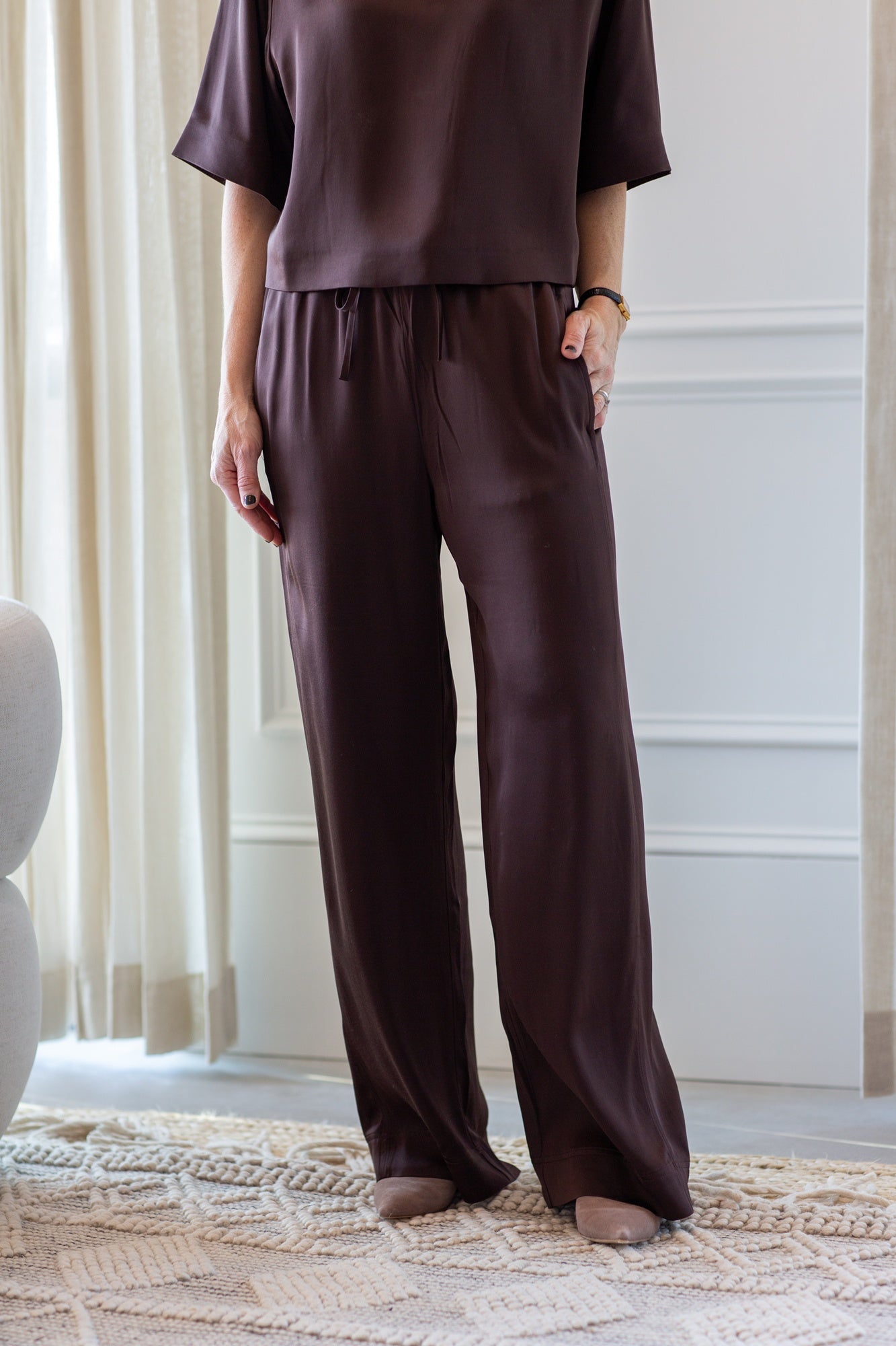 woman wearing the house of dagmar woven fluid shirt and drawstring trousers