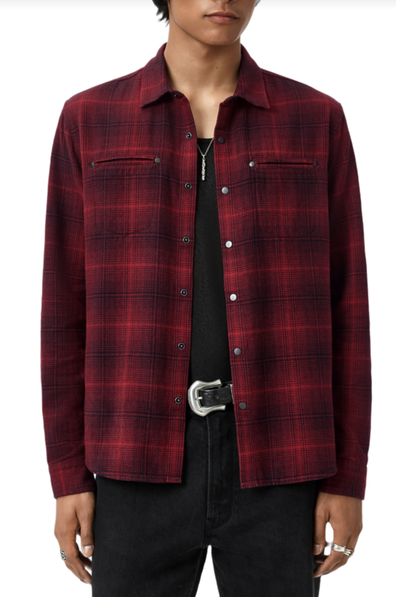 Red plaid shirt worn by a person on a white background