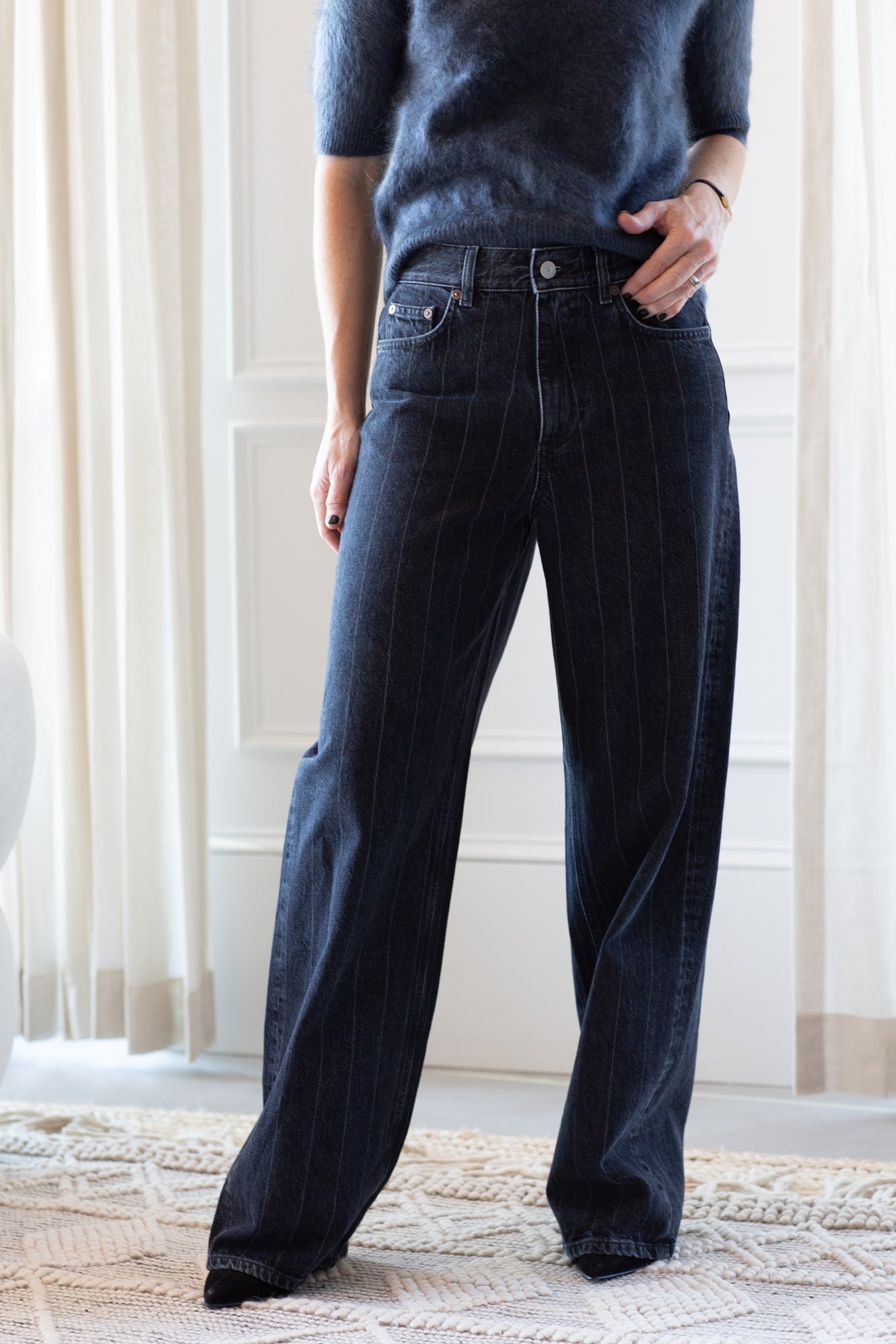 model wearing the lisa yang carolyn brushed cashmere sweater and house of dagmar baggy cut jeans