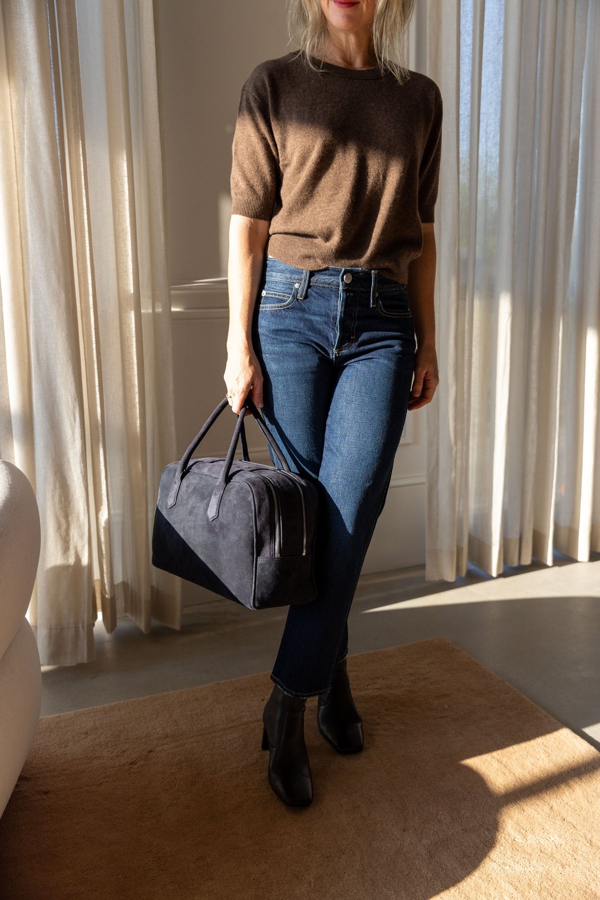 Lisa Yang Genevra T-Shirt in dark truffle cashmere with AMO jeans and A. Emery Talbot bag, three-quarter view
