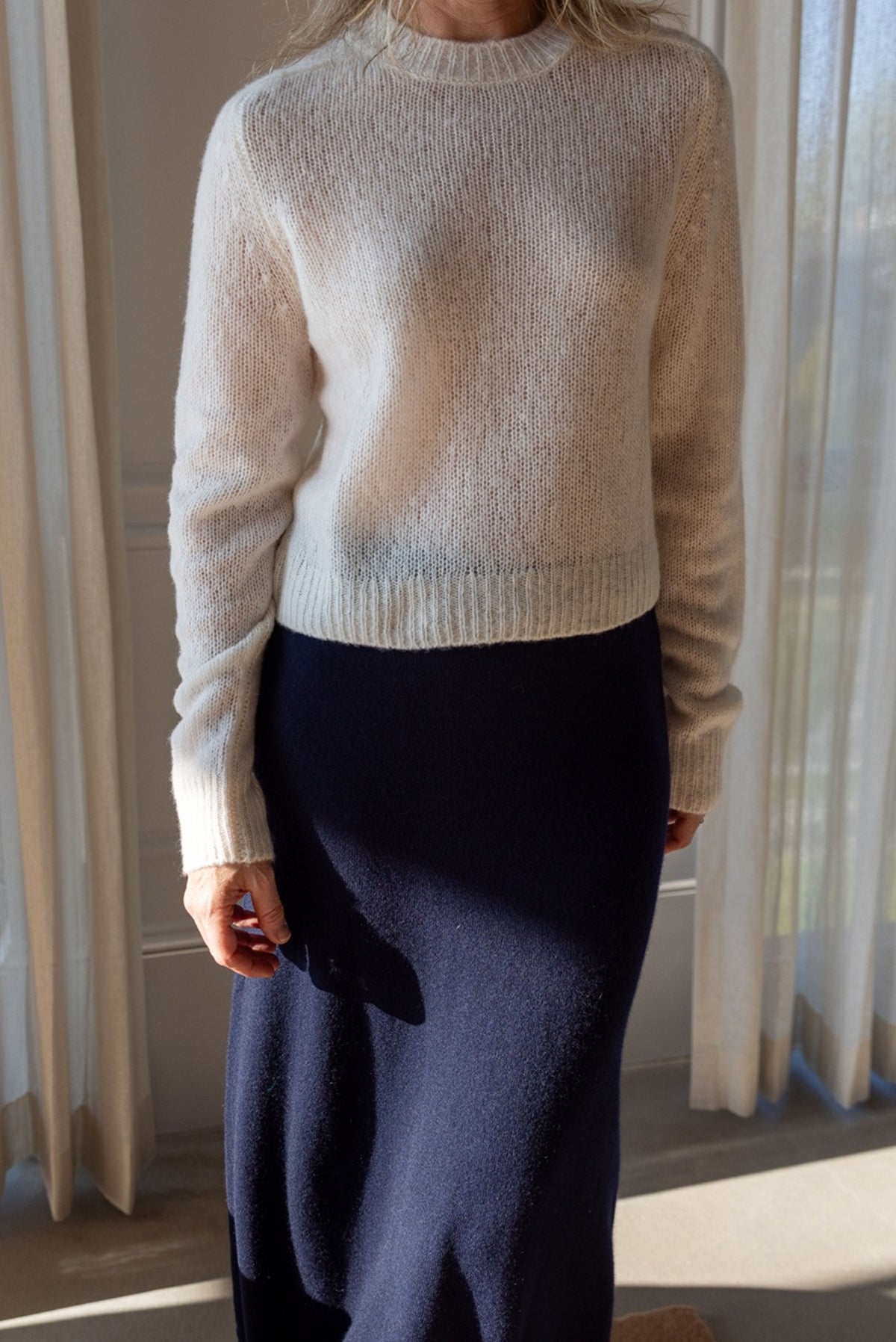 Lisa Yang Solene Sweater in cream silk cashmere, cropped crew neck, styled with the navy Dolly Skirt