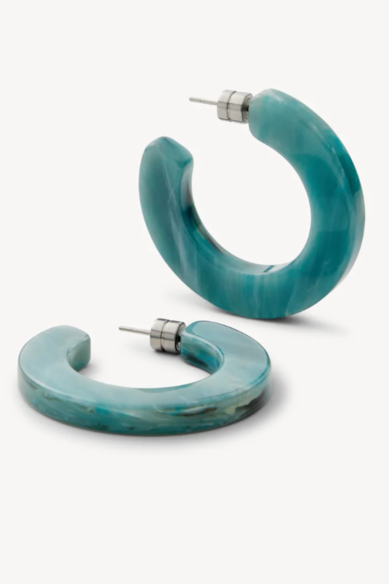 Pair of turquoise or jadeite hoop earrings on a white background