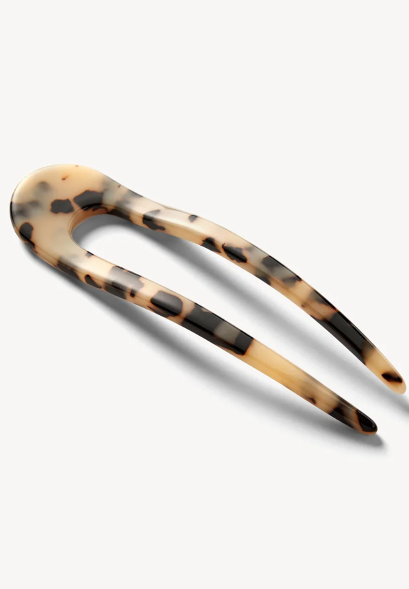 Tortoiseshell patterned hair clip on a white background
