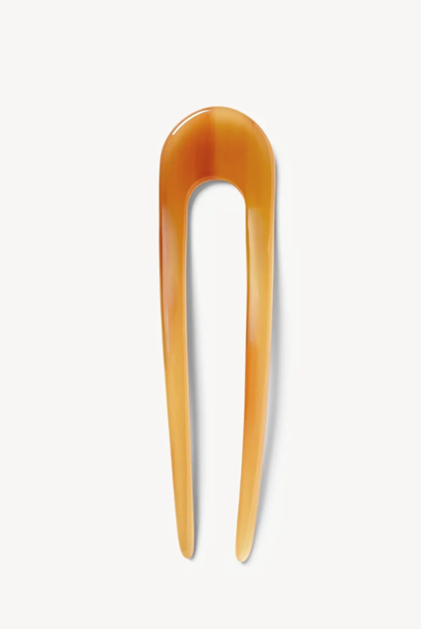 Cognac hair pick on a white background