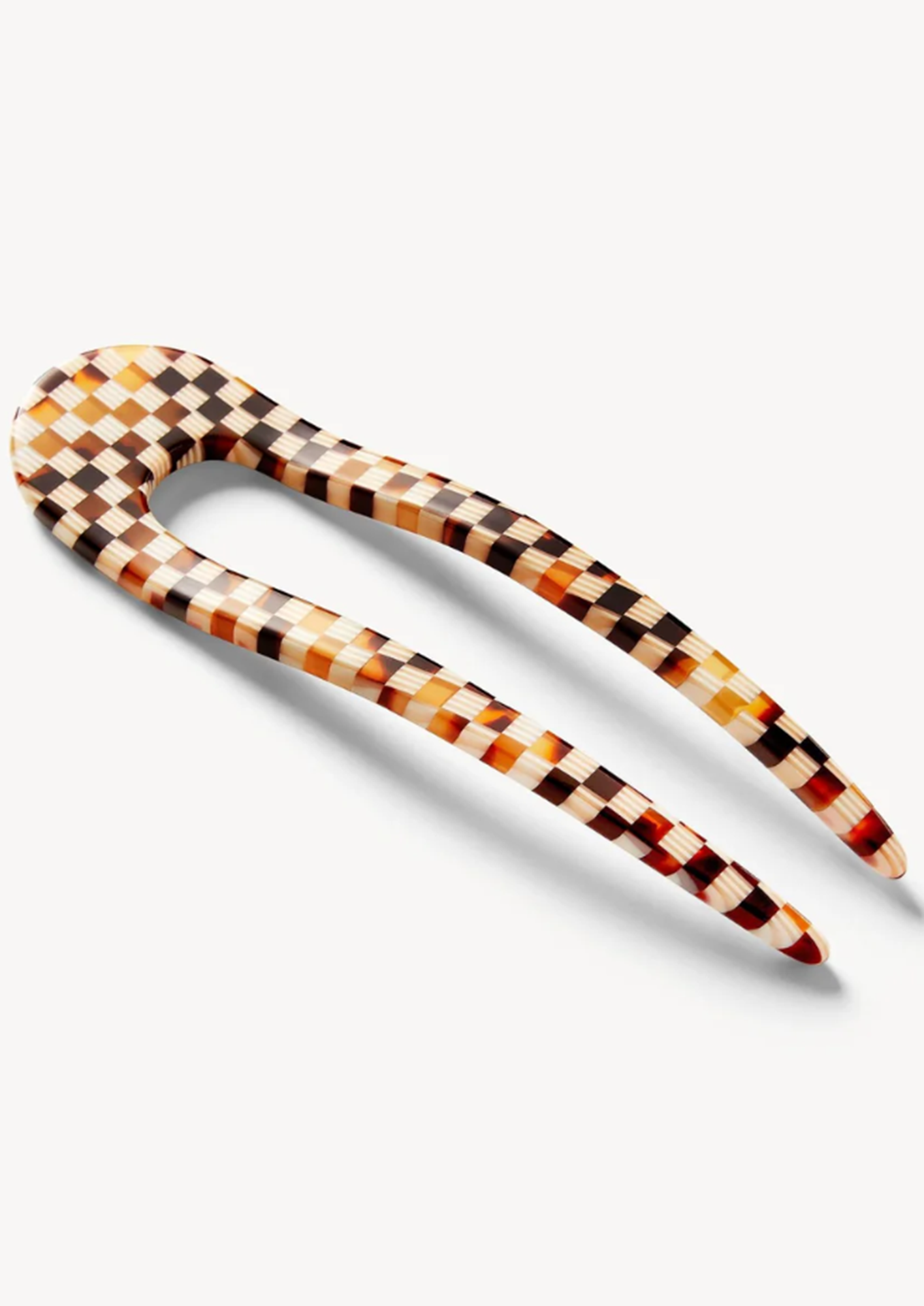 Tortoise checkered hairpin on a white background