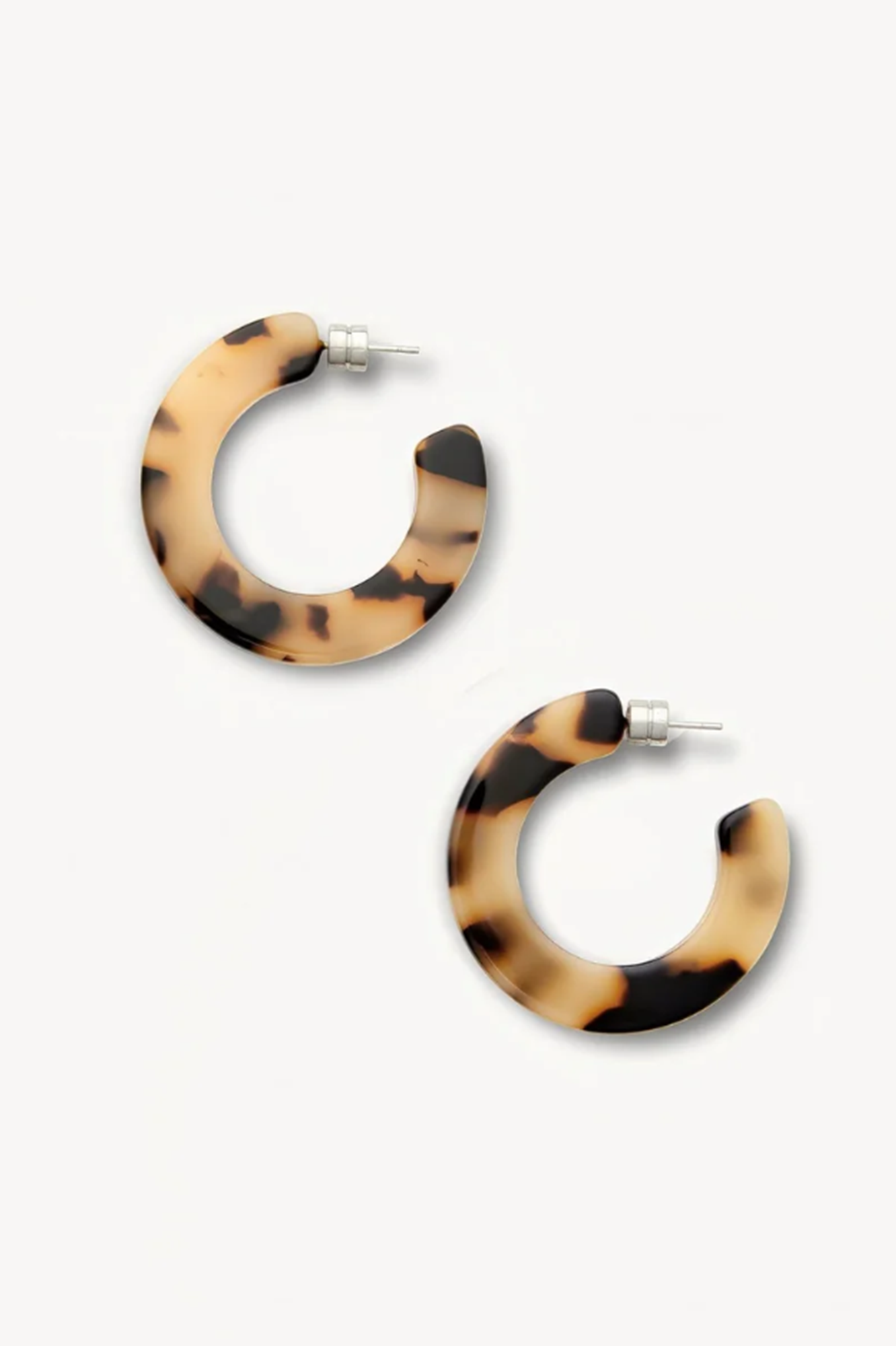Tortoiseshell hoop earrings on a white background