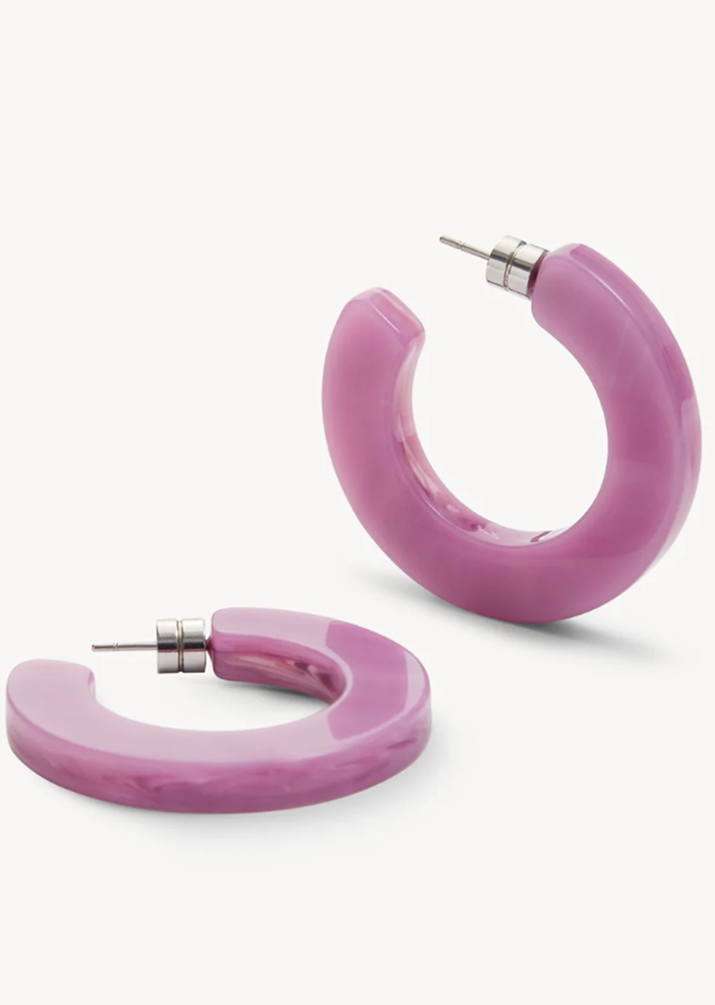 Pair of pink or orchid hoop earrings on a white background