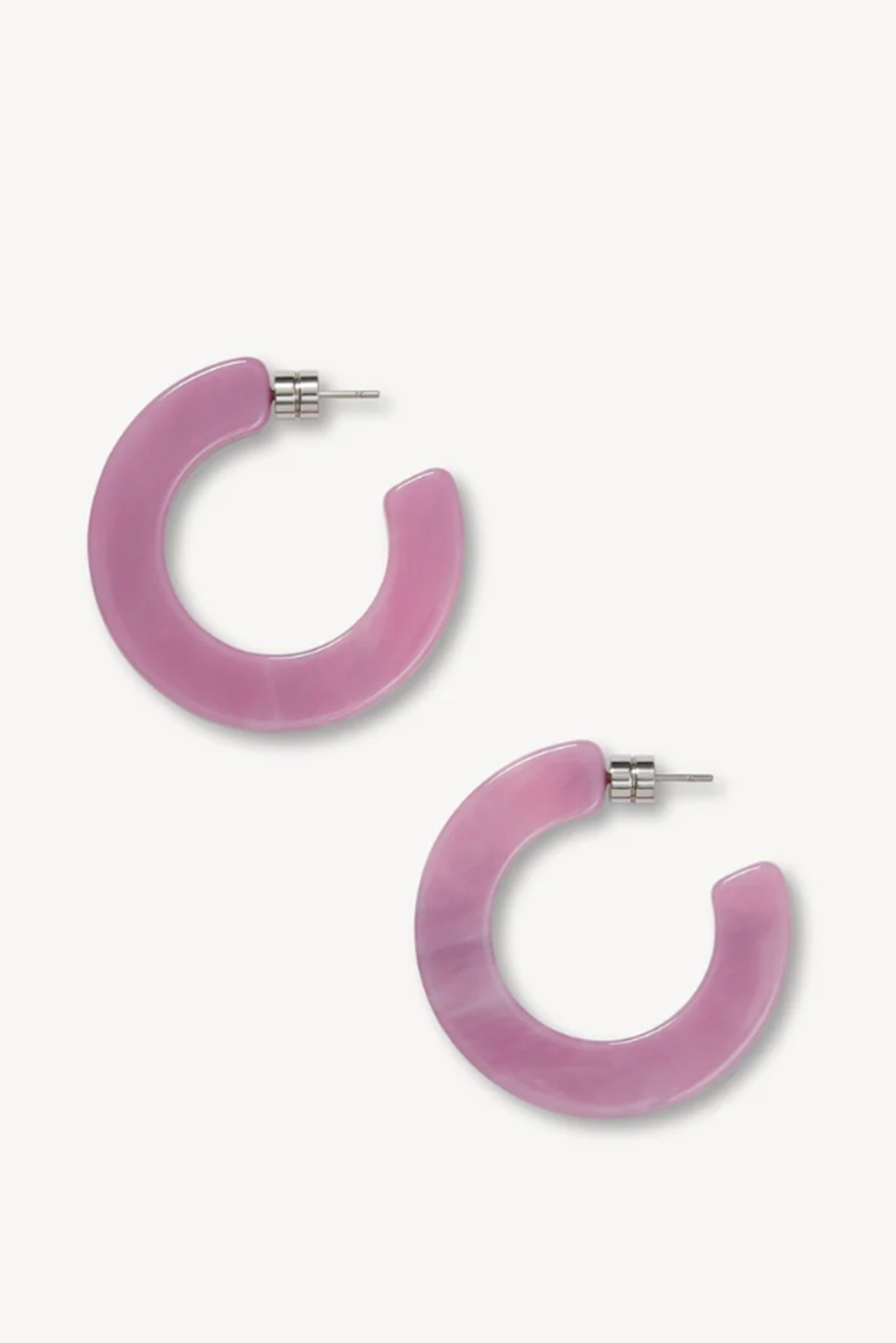Pair of pink or orchid hoop earrings on a white background