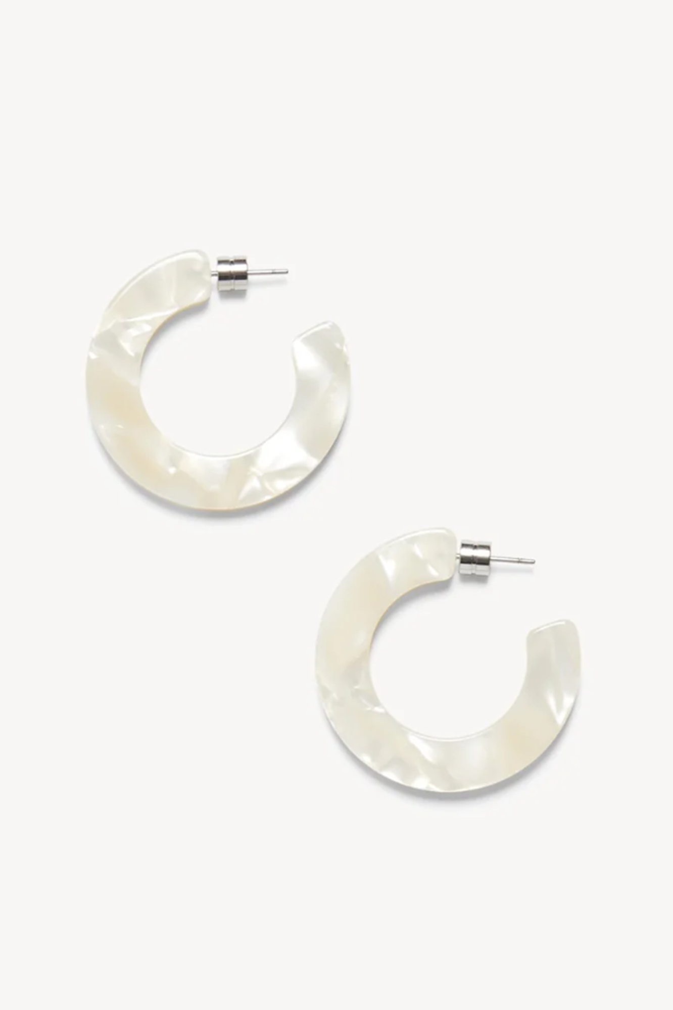 Pair of white or sea shell hoop earrings on a white background