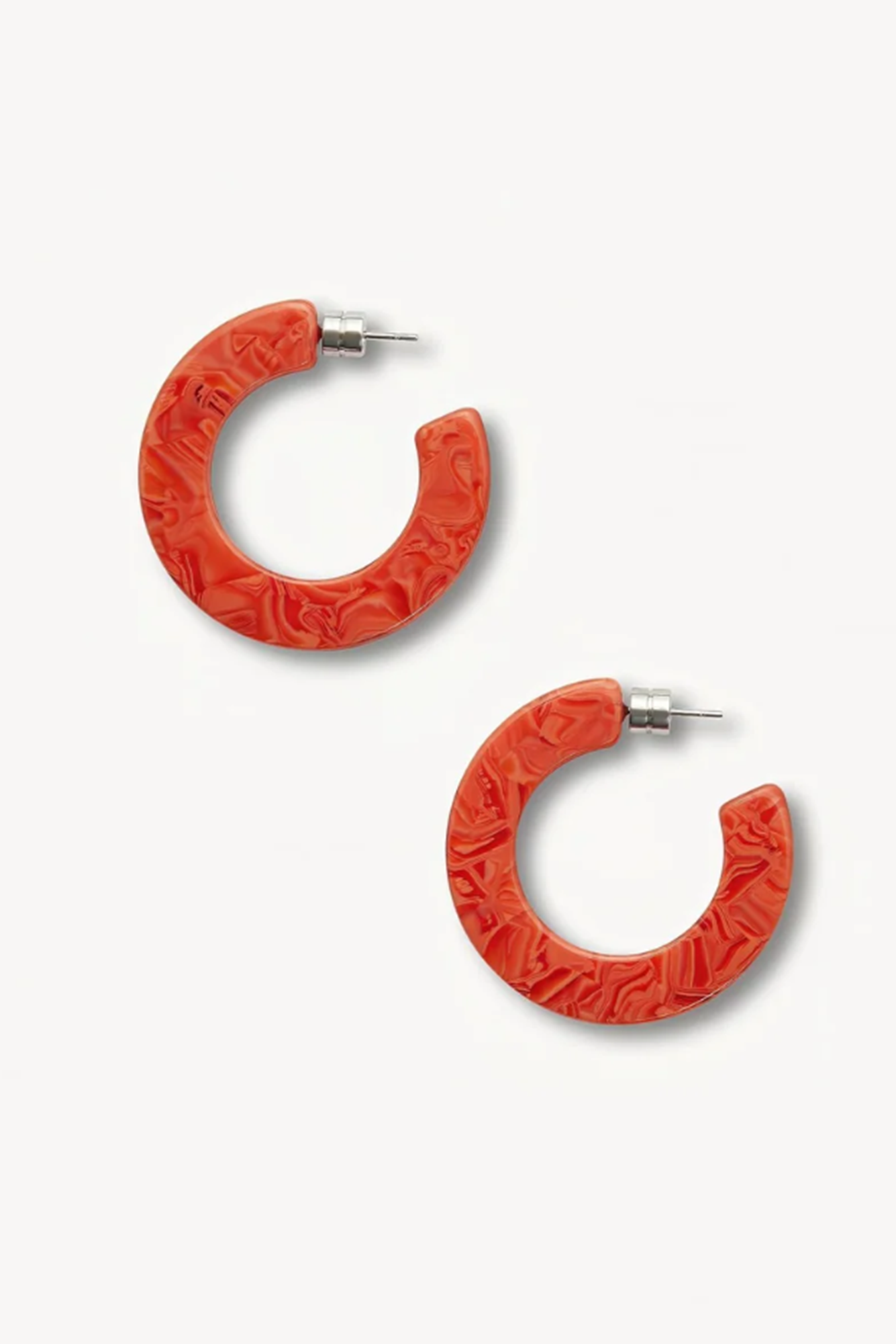 Red or poppy hoop earrings with textured design on a white background