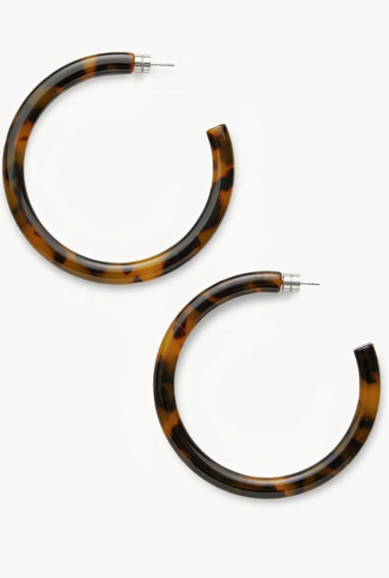 Tortoiseshell hoop earrings on a white background