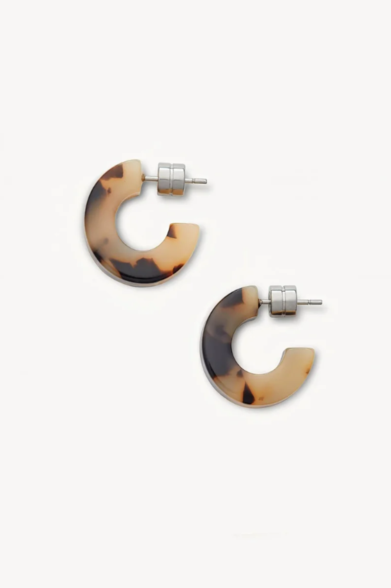 Pair of tortoiseshell hoop earrings on a white background