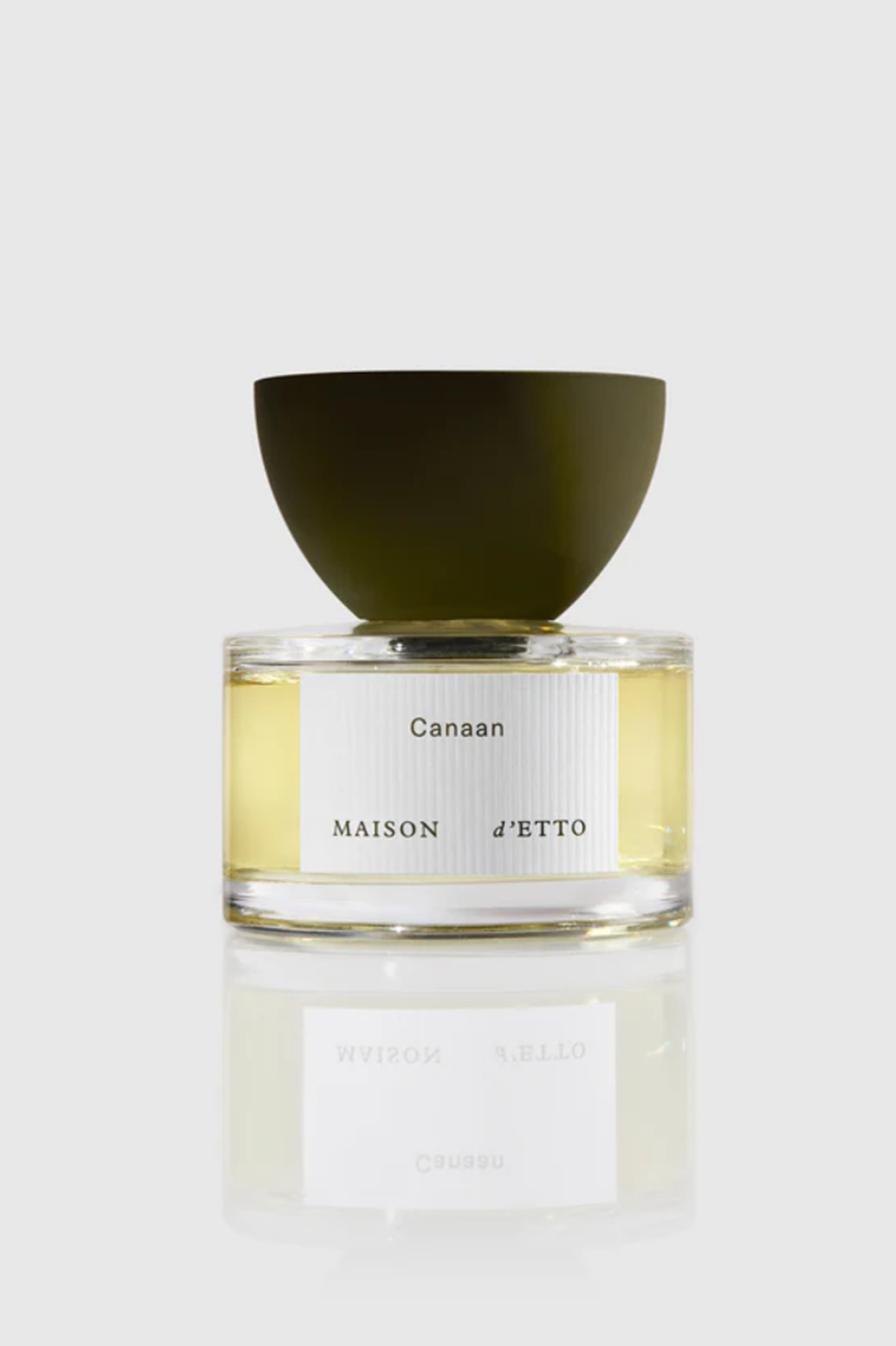 Perfume bottle labeled 'Canaan' by 'Maison d'Etto' on a white background