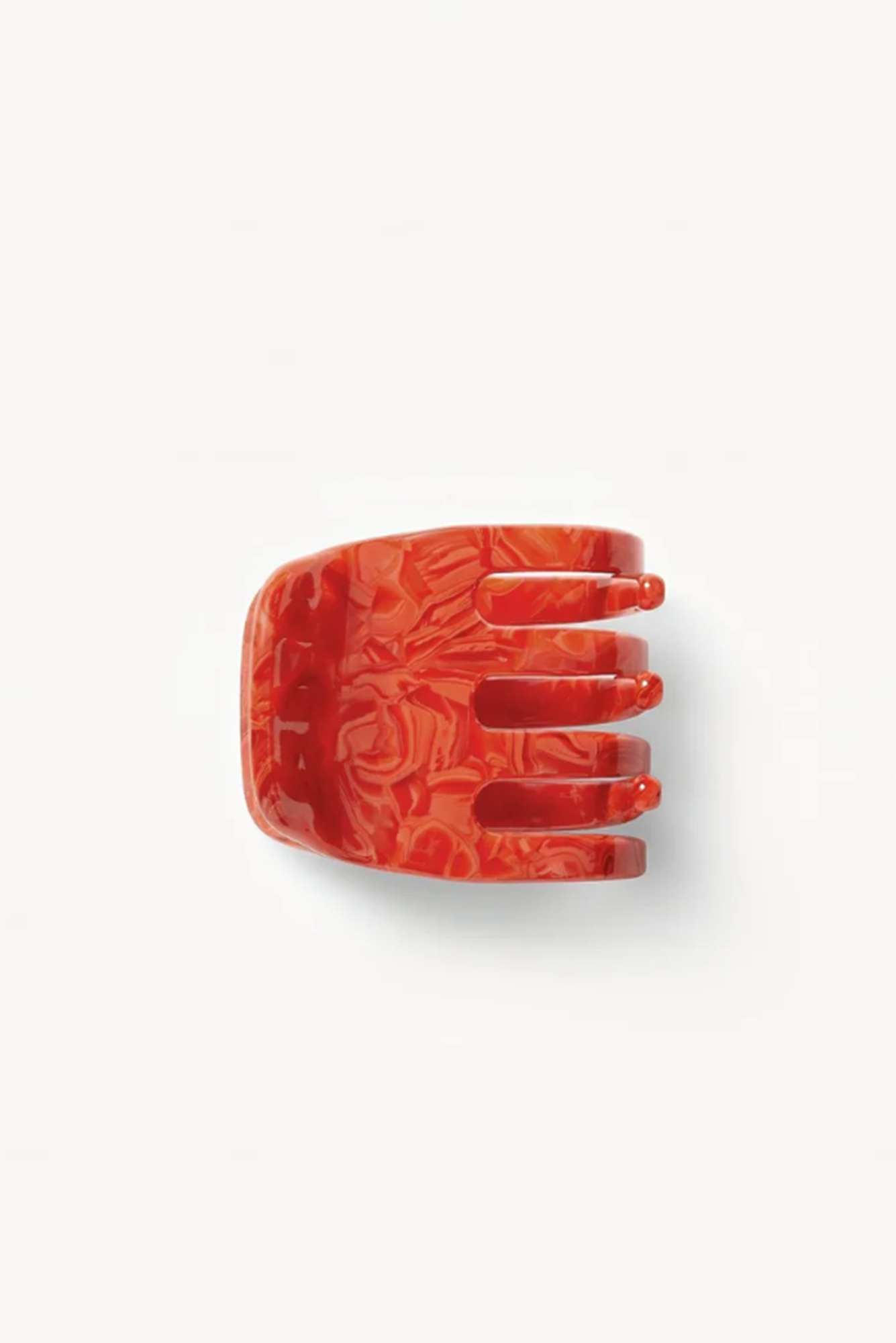 side view of a Red hair clip or claw on a white background