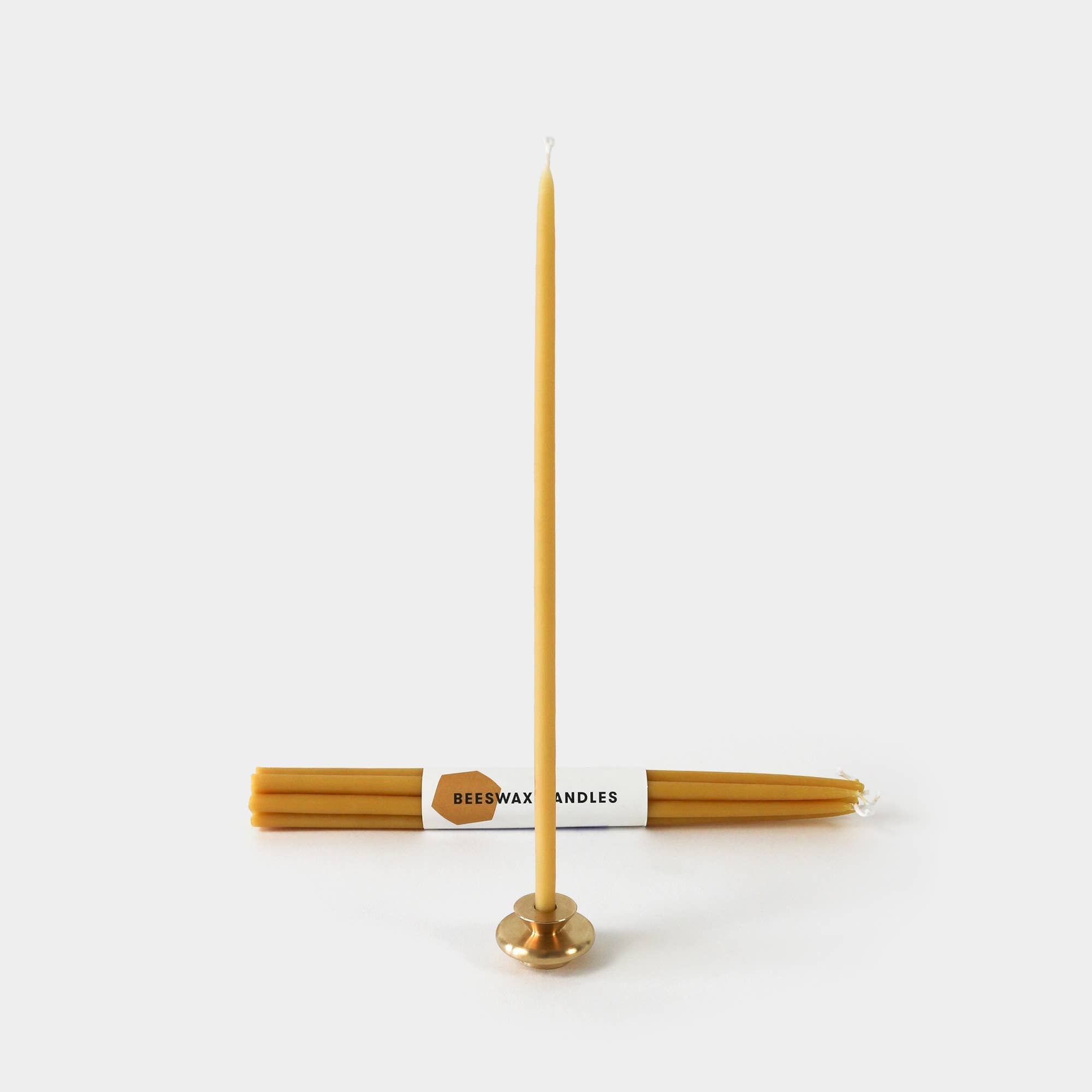 Beeswax candles with a holder on a white background