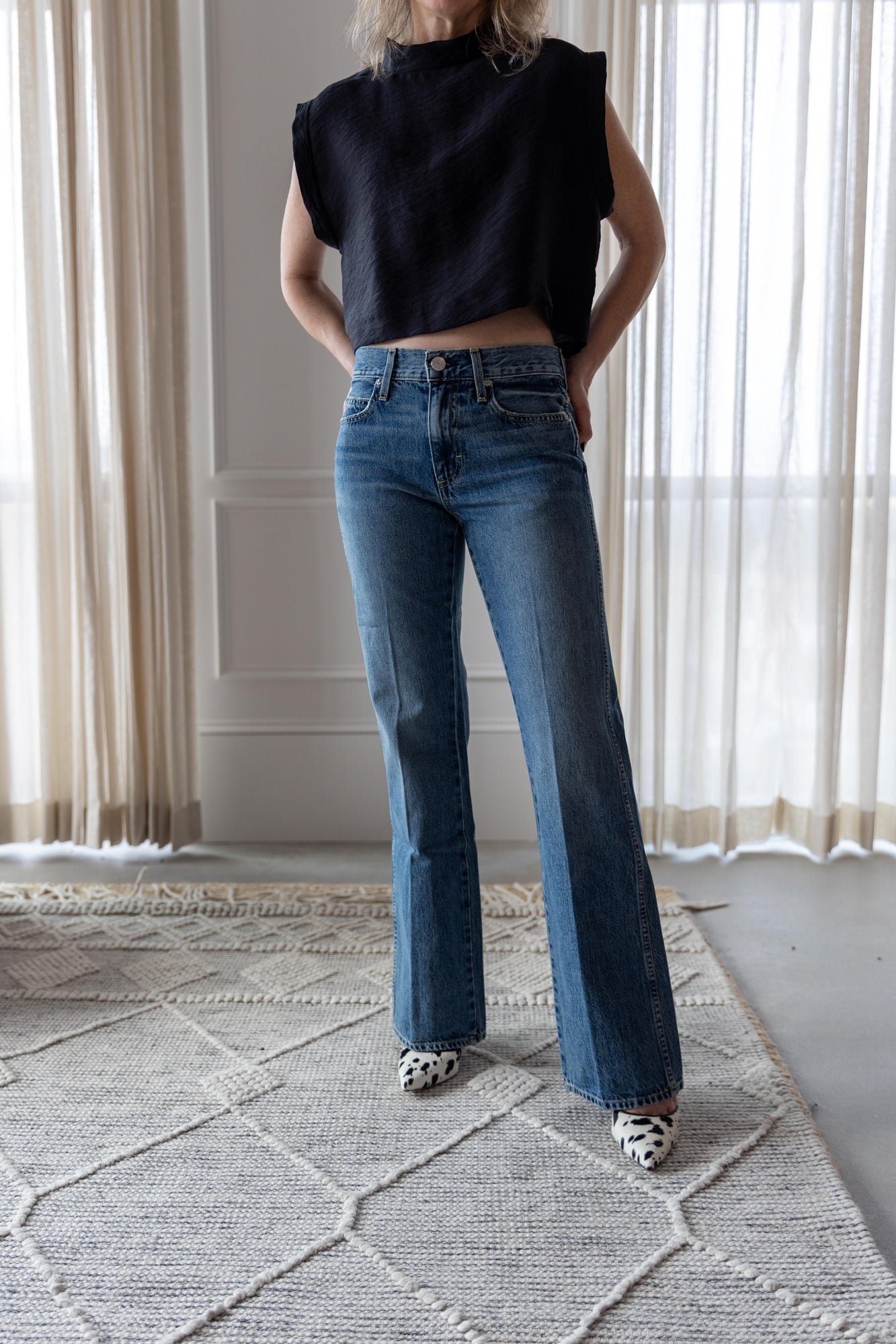 image of a woman wearing the Rachel Comey Bacchus top and Amo Marcenia Jeans
