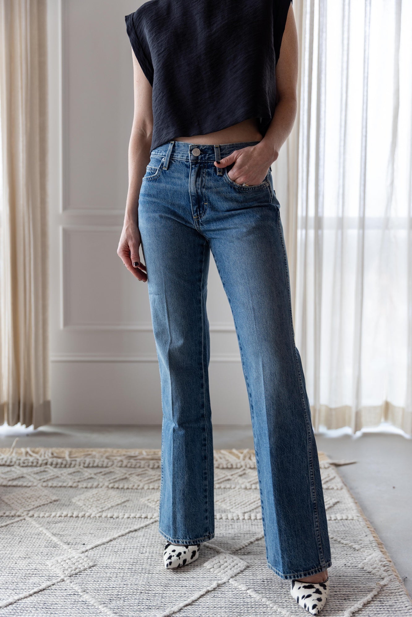 image of a woman wearing the Rachel Comey Bacchus top and Amo Marcenia Jeans