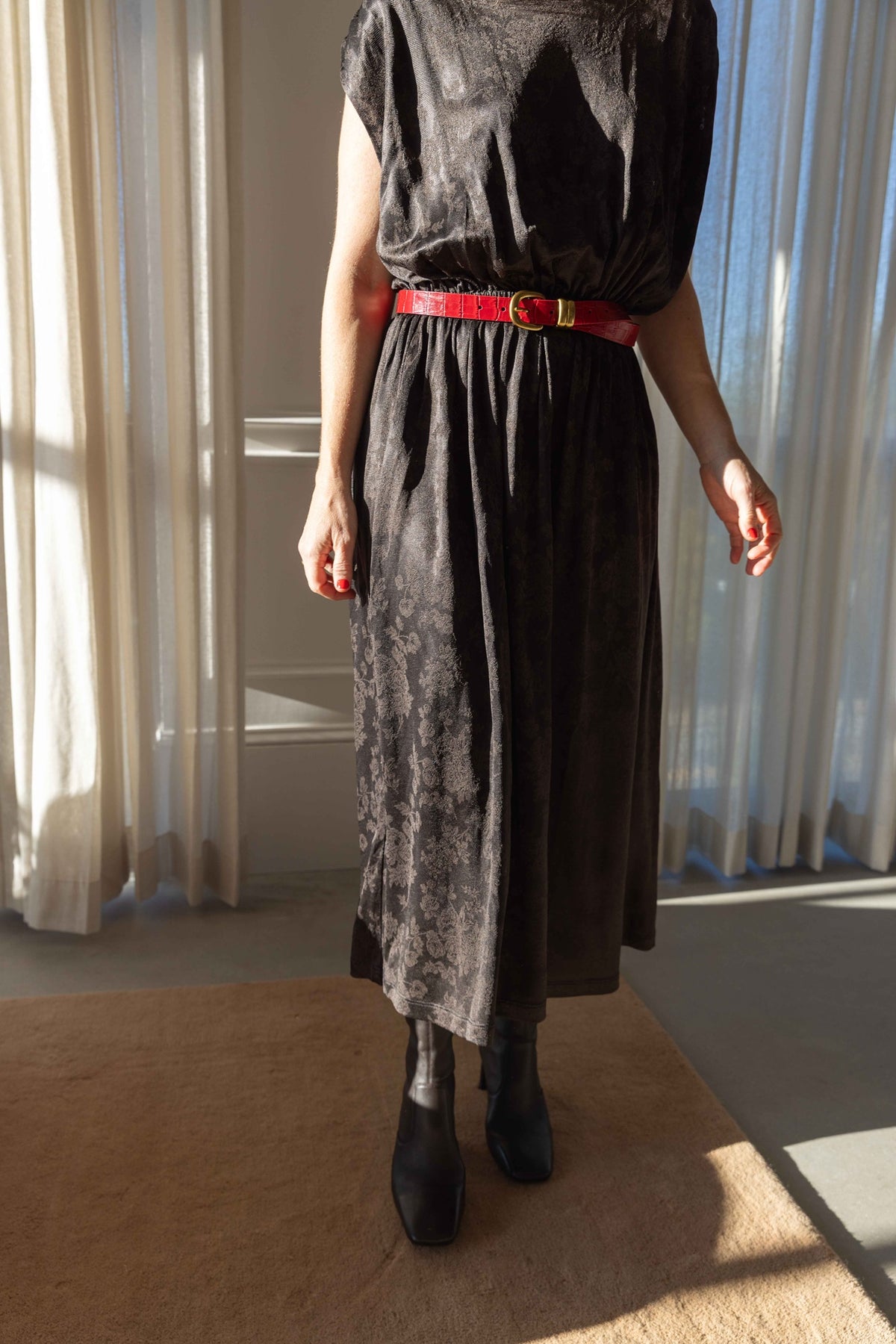 by Malene Birger Zoilo Belt in Red Dahlia cinching a dark jacquard midi dress, cropped front view