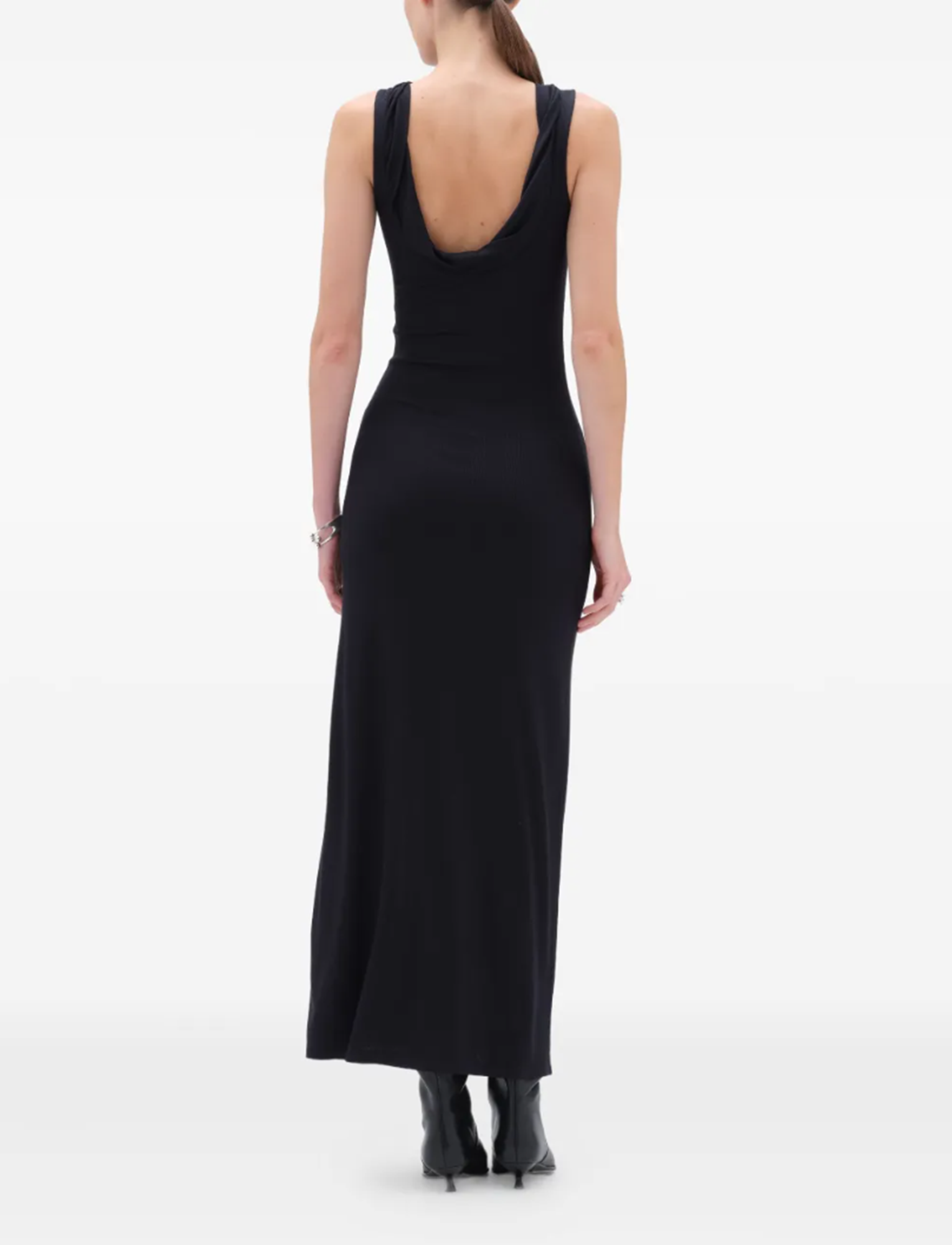 Black sleeveless dress worn by a person on a white background