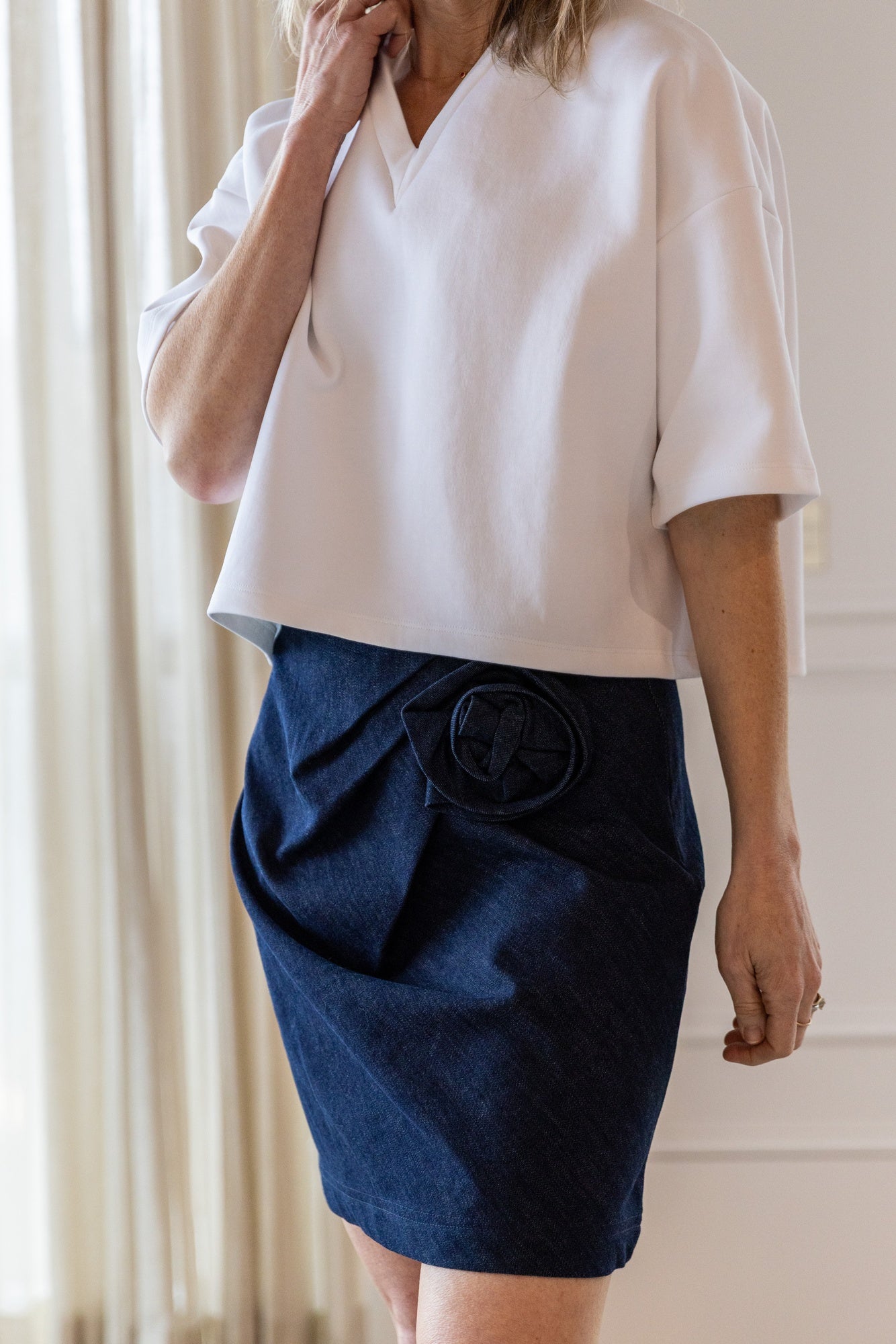 image of a woman wearing the Rhune Ella v neck top and Moira Skirt