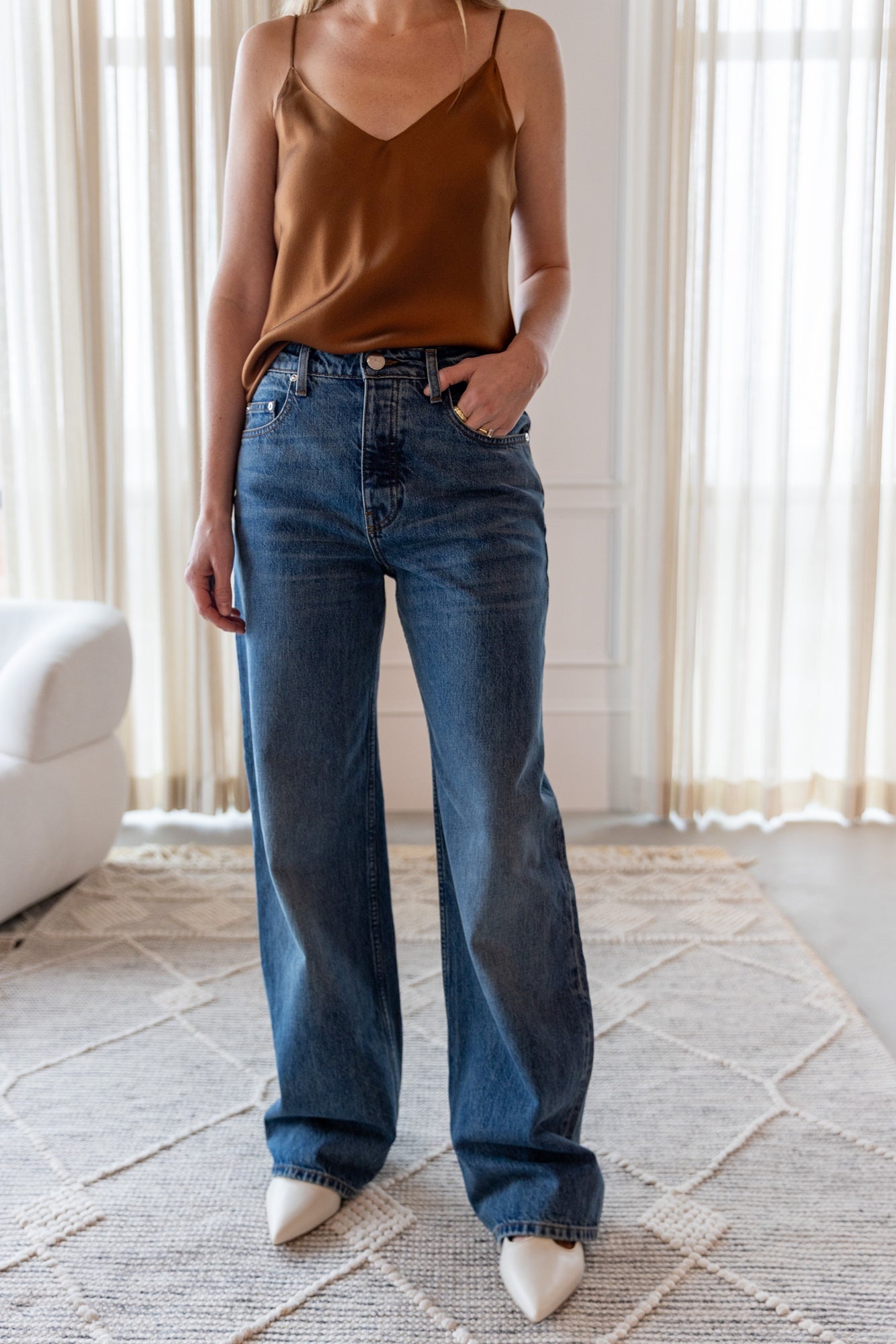 image of a woman wearing the Sablyn Gloria V Neck Camisole and Sammy Jeans