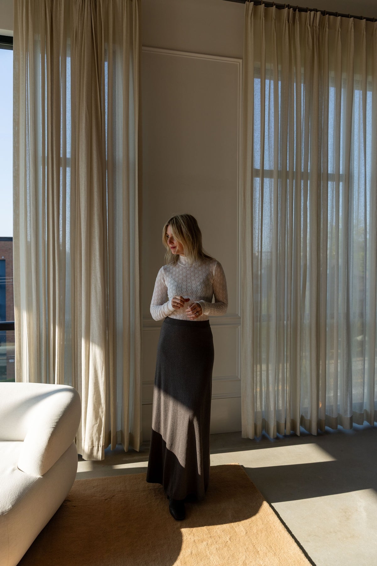 Lisa Yang Adrienne Skirt and Sablyn Rhea turtleneck, full-length view by the window