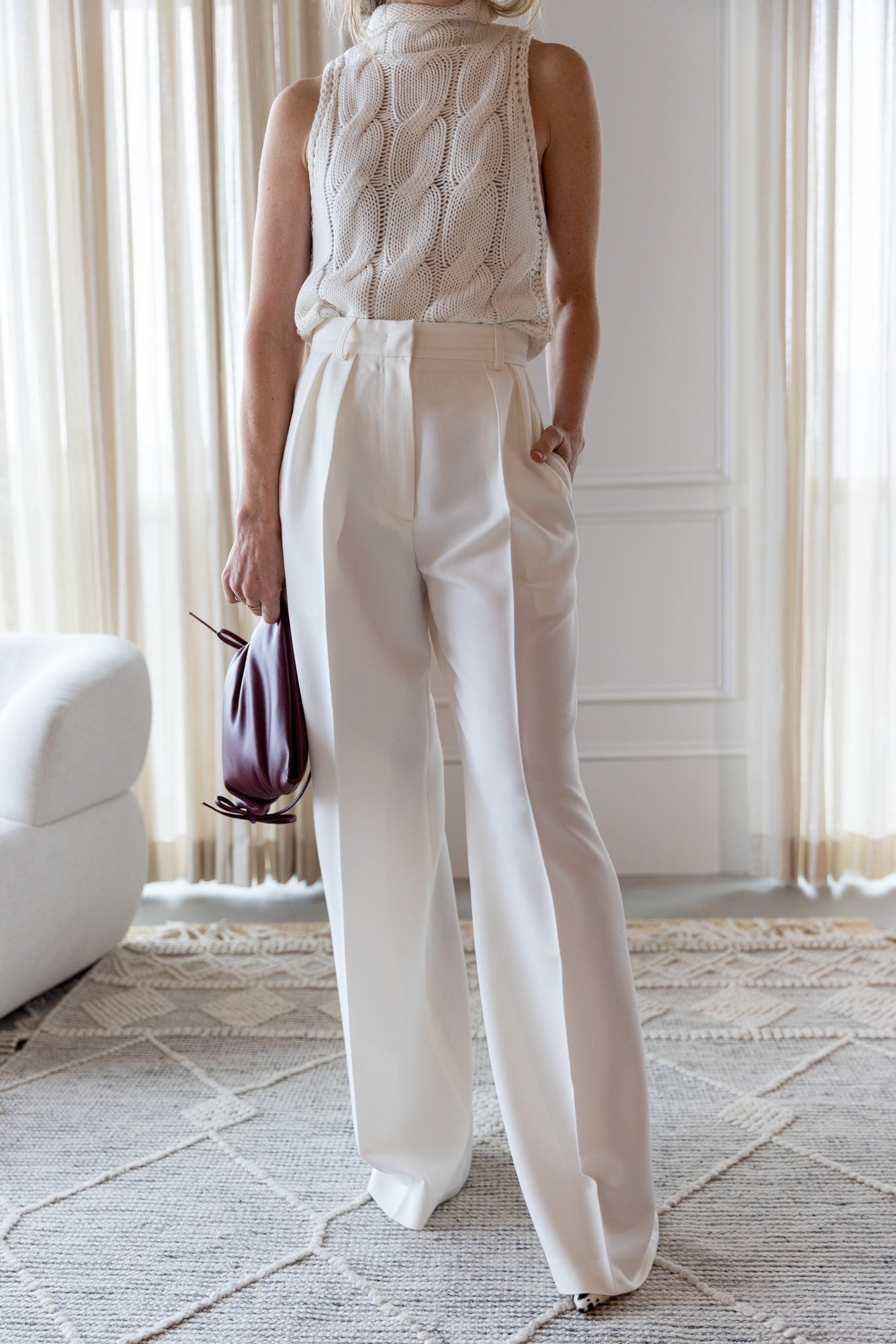 image of a woman wearing the Sablyn Salvia Knit Top and Rhune Celine Pants in White