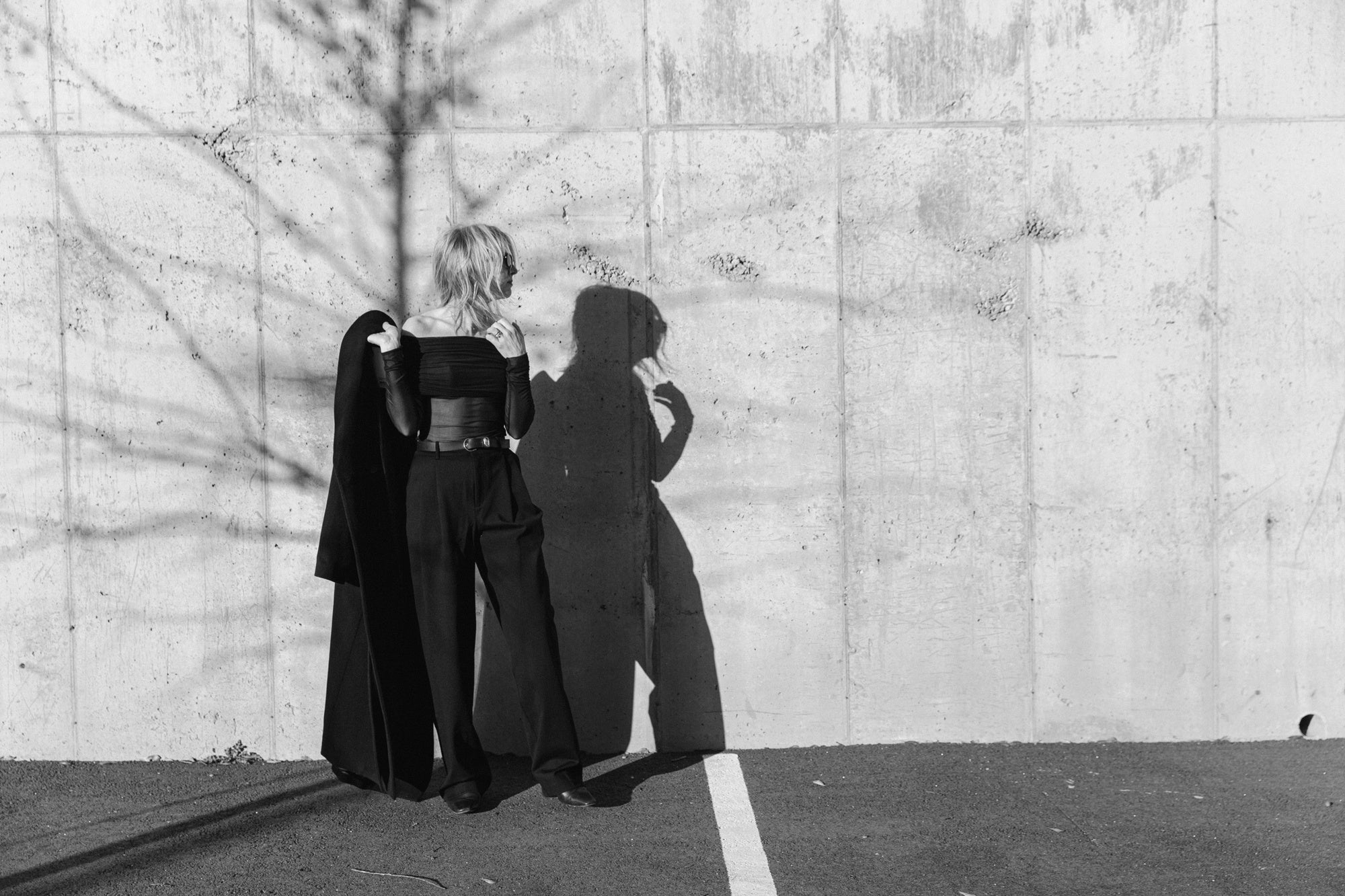 image of a woman wearing the seroya rosa top and sonya pants with the house of dagmar coat