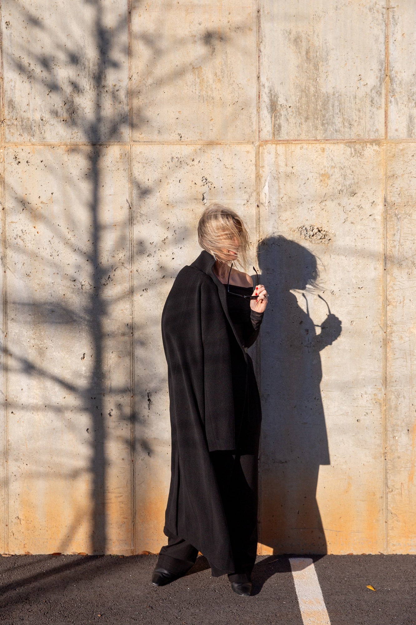 image of a woman wearing the seroya rosa top and sonya pants with the house of dagmar relaxed wool coat