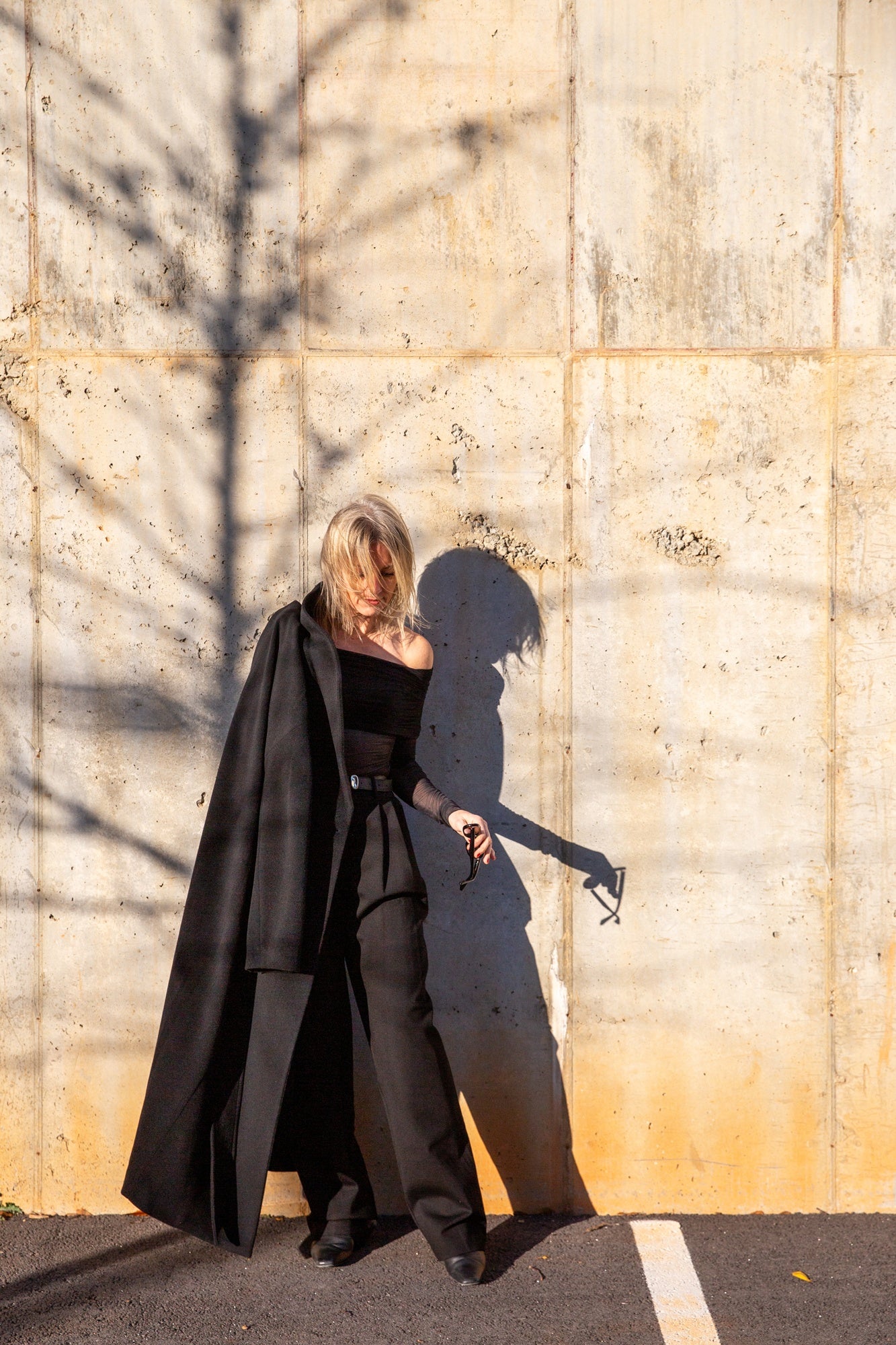 image of a woman wearing the seroya rosa top and sonya pants with the house of dagmar relaxed wool coat