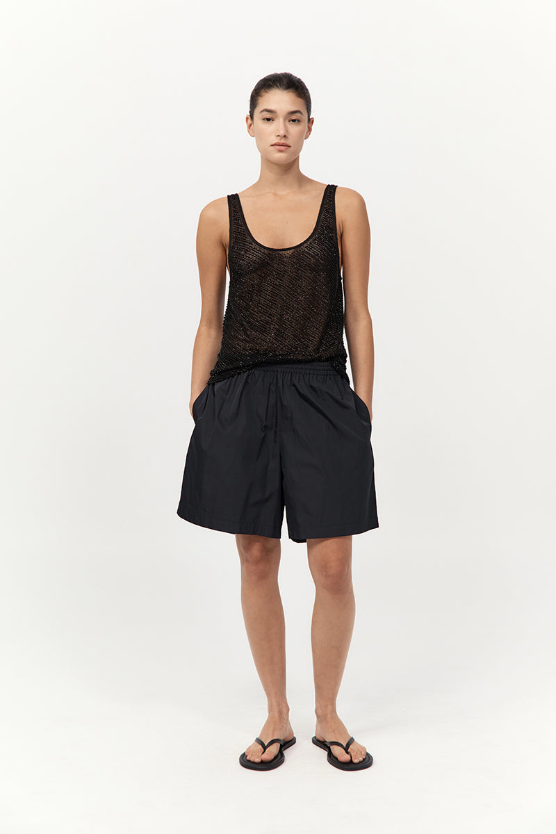 model wearing the st agni glass beaded mesh top