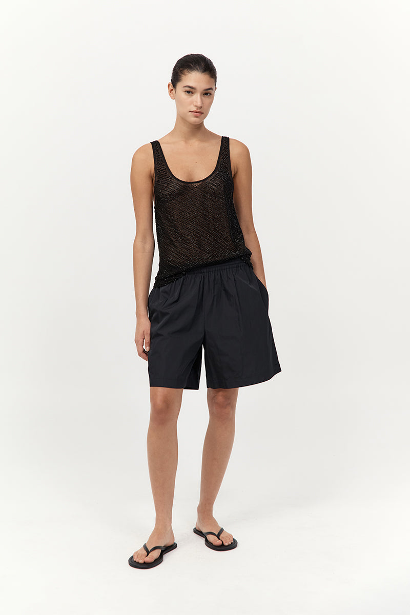 model wearing the st agni glass beaded mesh top