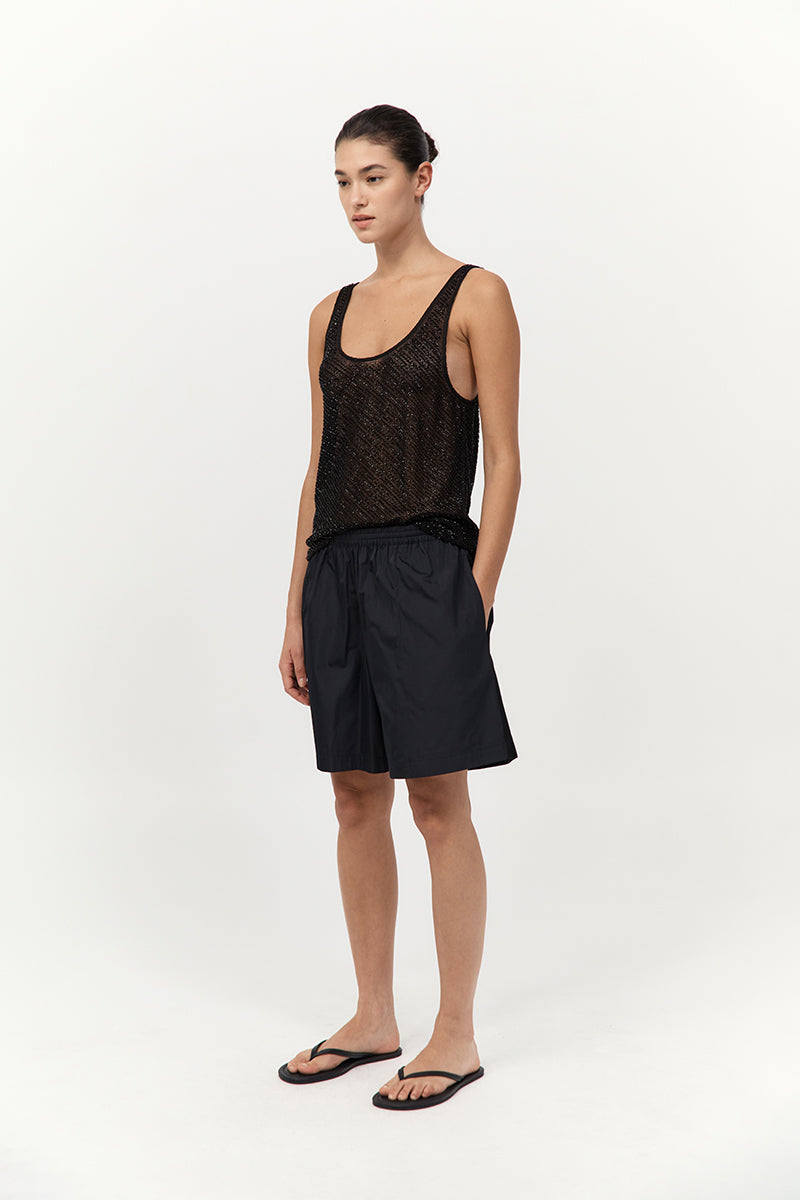 model wearing the st agni glass beaded mesh top