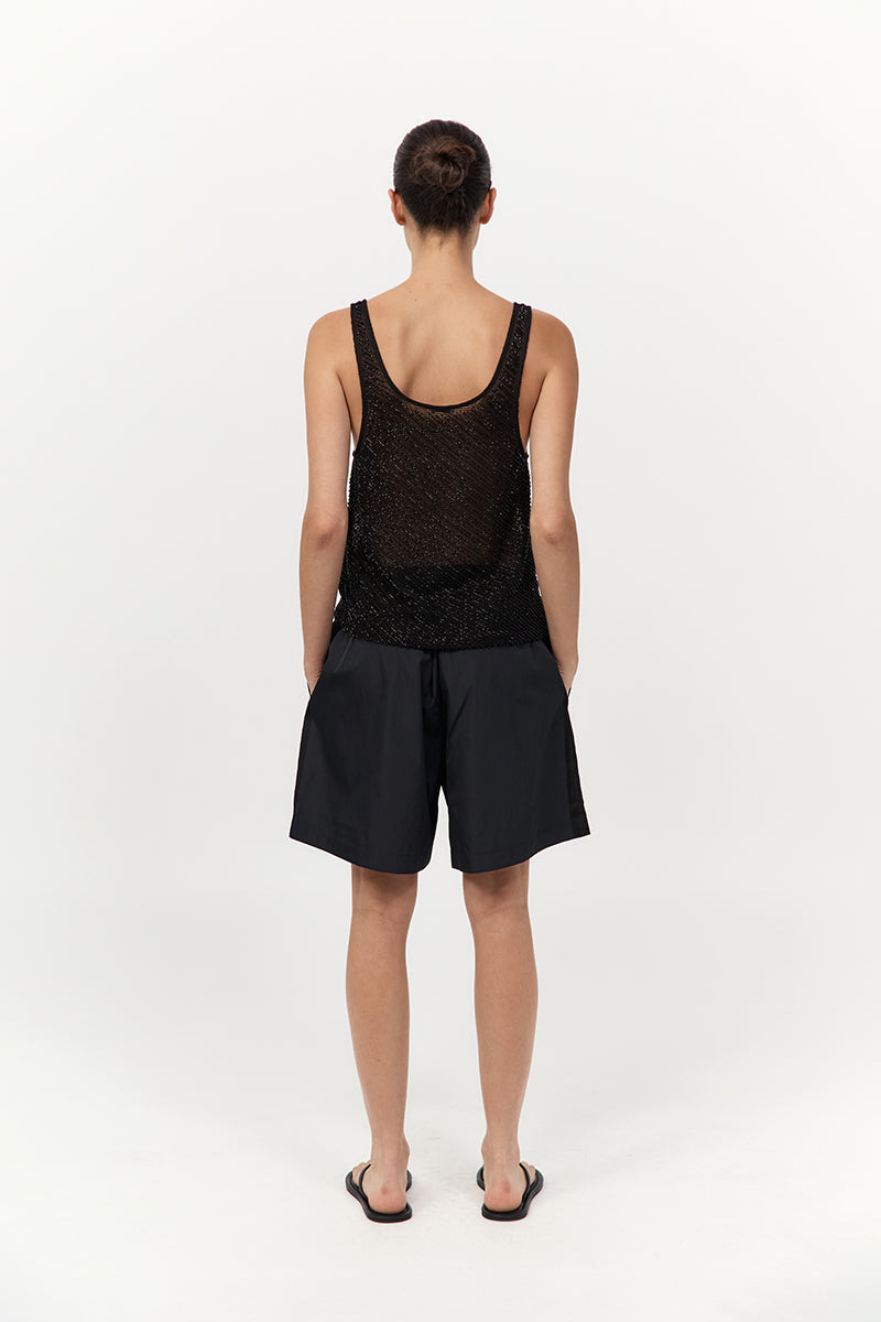 model wearing the st agni glass beaded mesh top