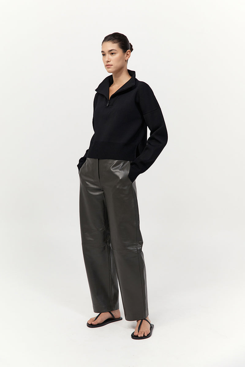 Person wearing a black outfit with a white background