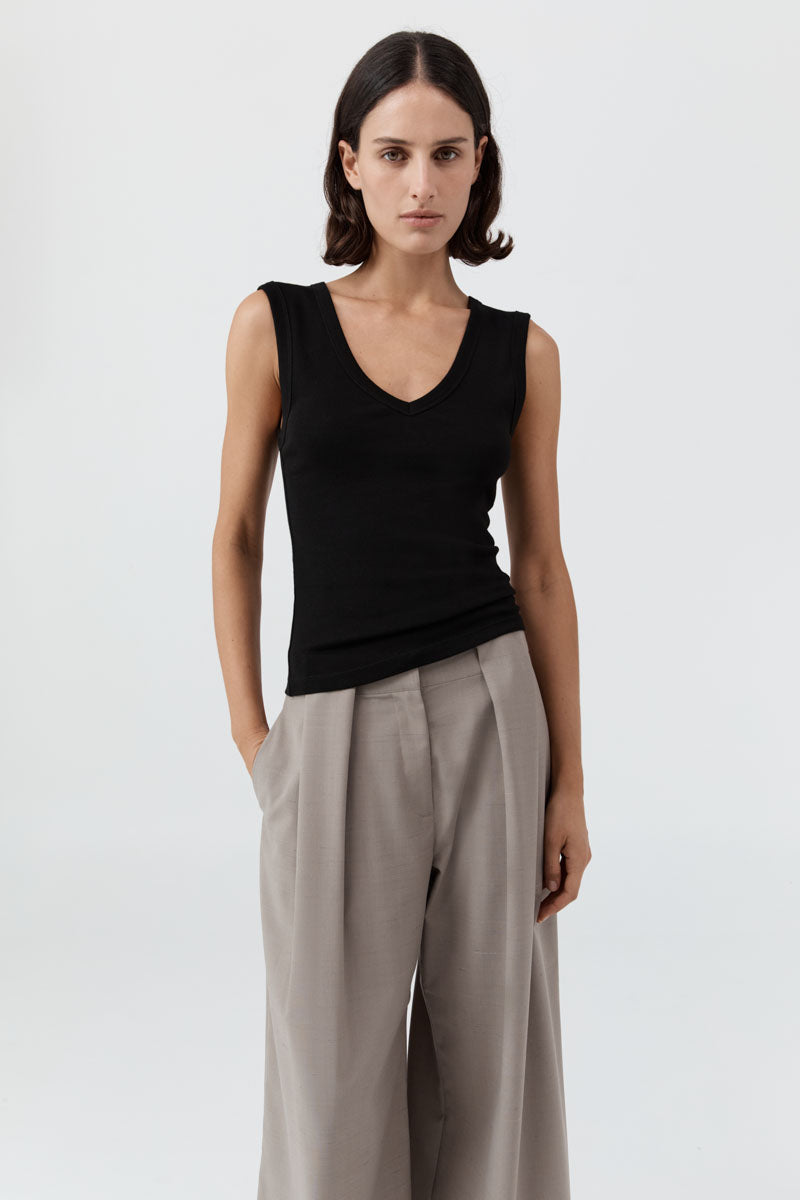 image of a woman wearing the st agni organic cotton 90's tank in black