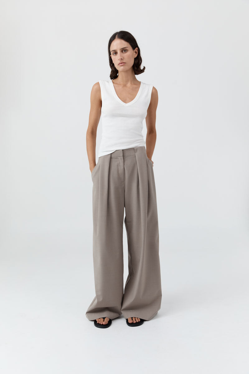 image of a model wearing the st agni organic cotton 90s tank in white