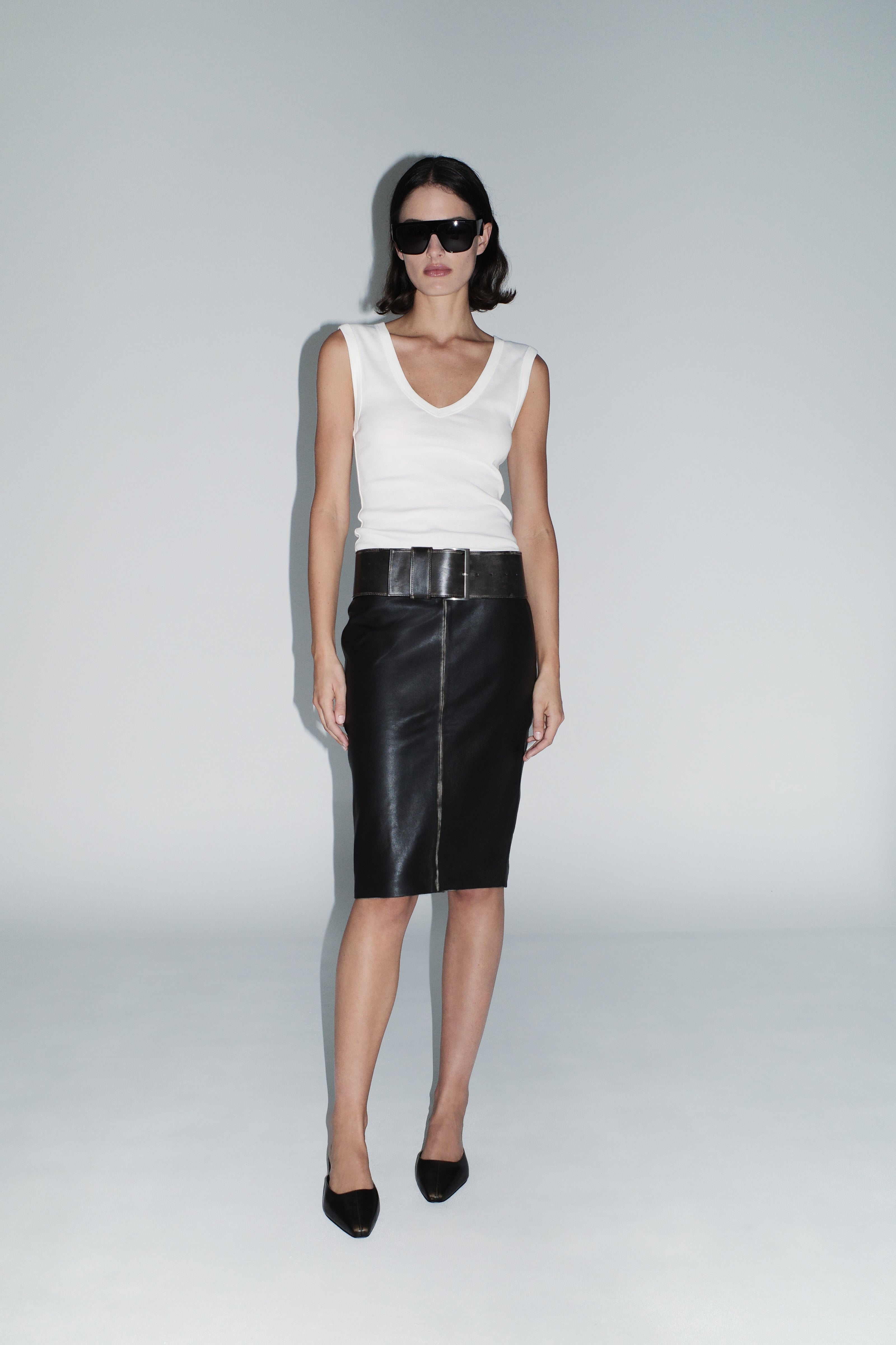 image of a woman wearing the st agni organic cotton 90s tank in white