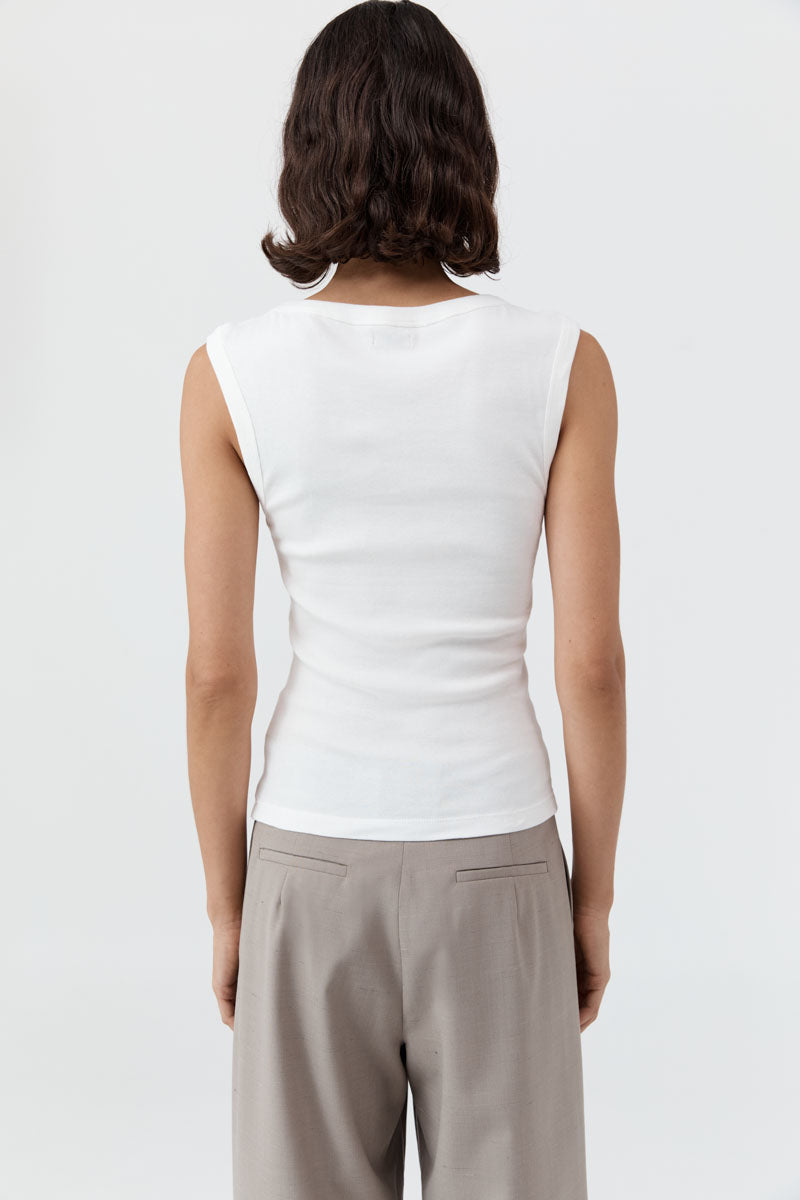 image of a woman wearing the st agni organic cotton 90s tank in white