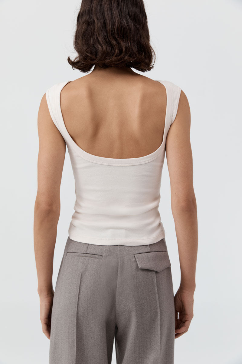 image of a woman wearing the st agni organic cotton ballerina top in shell pink