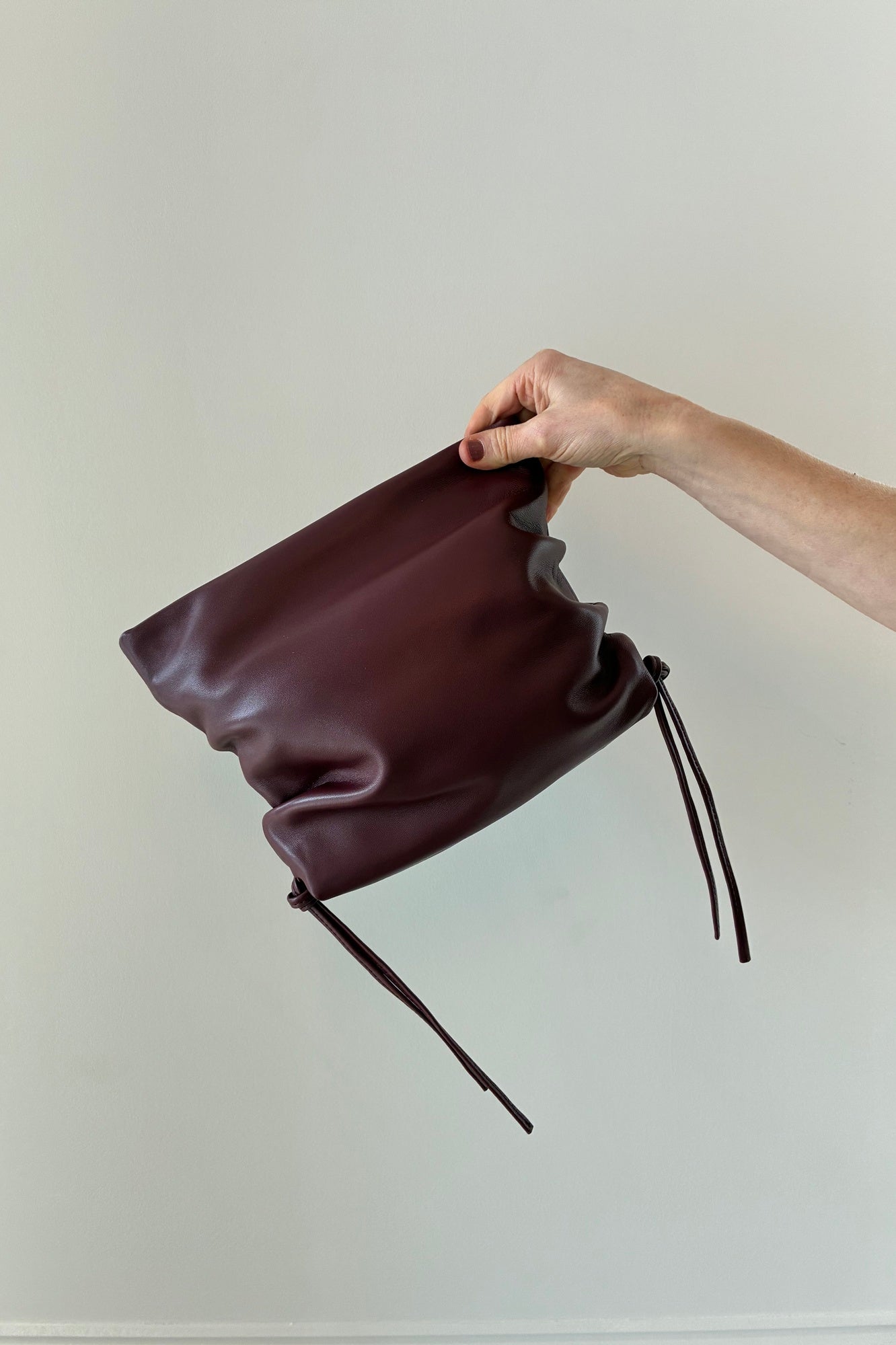 image of the Studio Amelia Ruched clutch in merlot