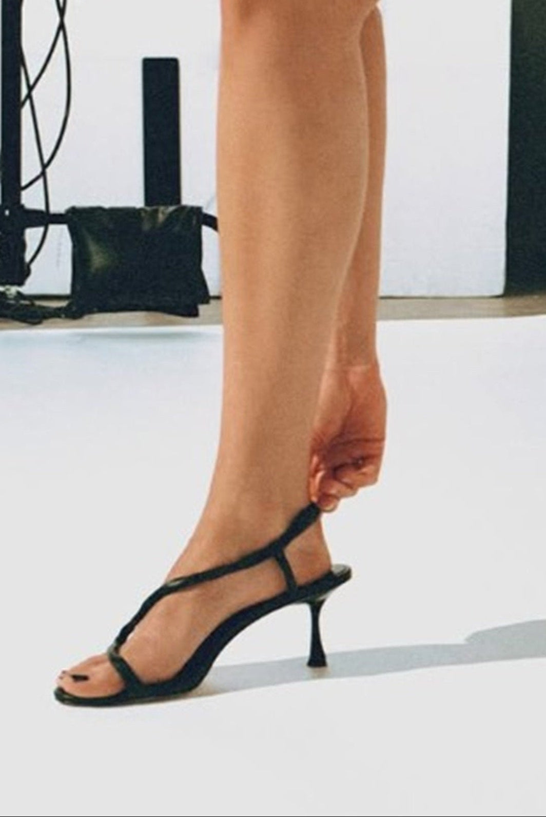 Black high-heeled sandal on a white background